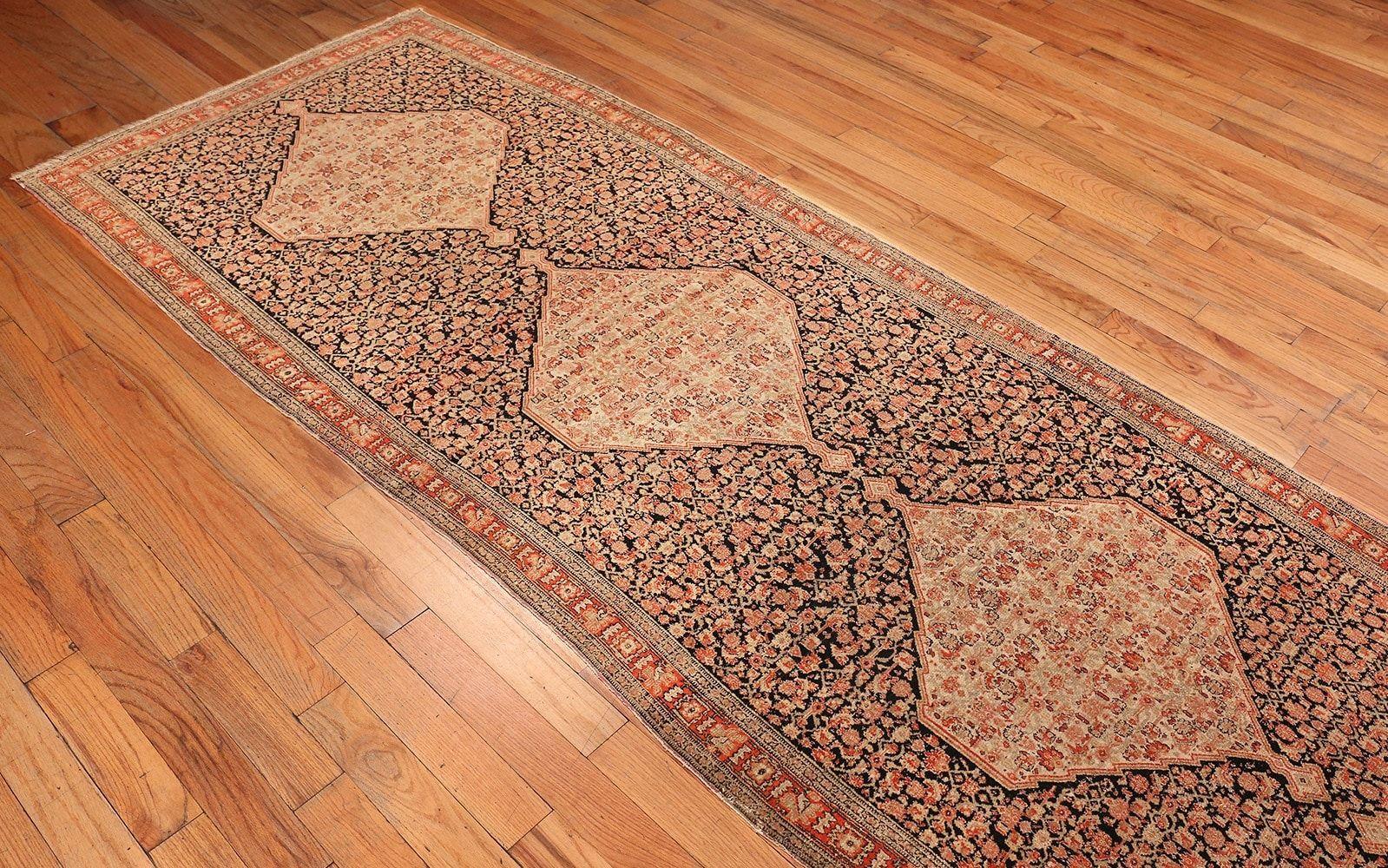 Antique Persian Senneh Runner Rug, Country Of Origin: Persia, Circa Date: Turn of the Twentieth Century – Size: 3 ft 10 in x 19 ft 2 in (1.17 m x 5.84 m)

A unique composition, this antique Persian Senneh rug exhibits tremendous detail throughout