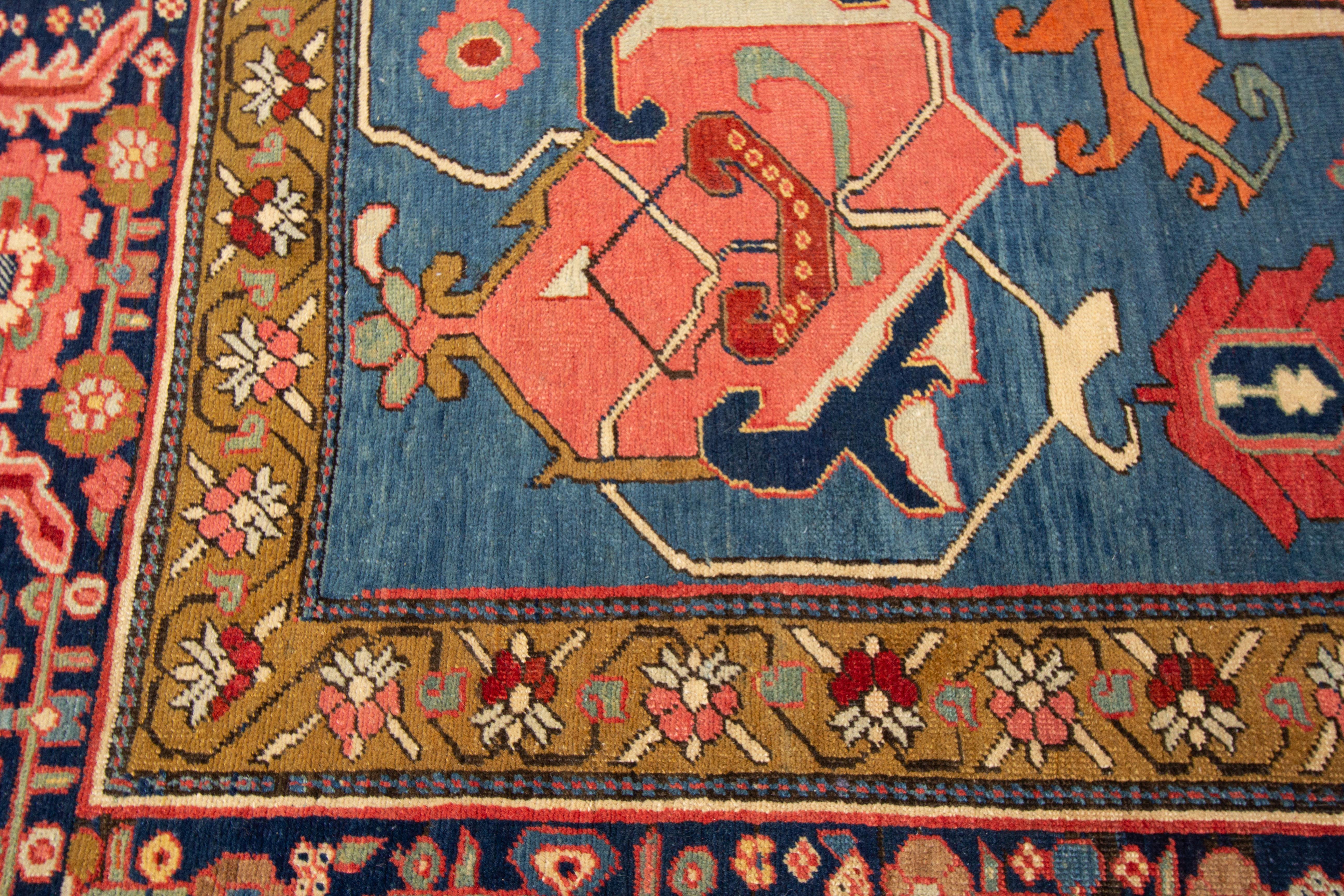 A hand knotted antique Serapi rug with a medallion geometric design. This piece would be the perfect addition to your home. This rug measures 11'8