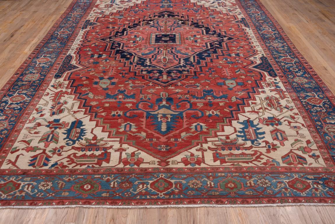 Persian Antique Serapi Rug with Cream and Red Field and Corner Foliage For Sale