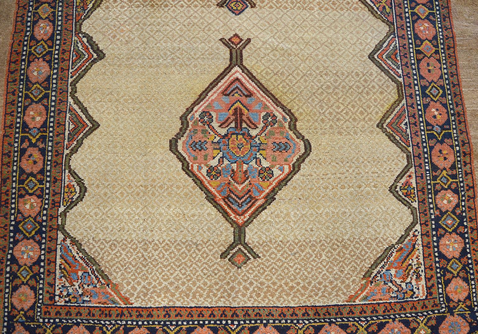 This antique Seraband Persian carpet in handspun camel wool is hand knotted in a Persian Seraband weave and uses organic vegetal dyes, circa 1880. Characterized by its unique coloration of camel, gold, light blue, pink and green, the balanced design
