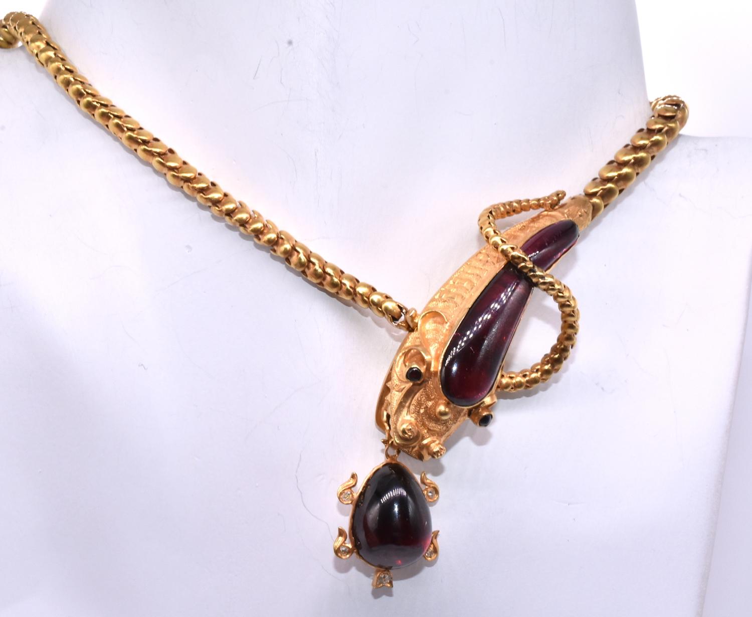 The detail on this fabulous 18K serpent choker astounds. In forty years of buying and selling antique jewelry, we have never seen a necklace like this one, designed with incredible precision and charm. The necklace features a serpent's head with