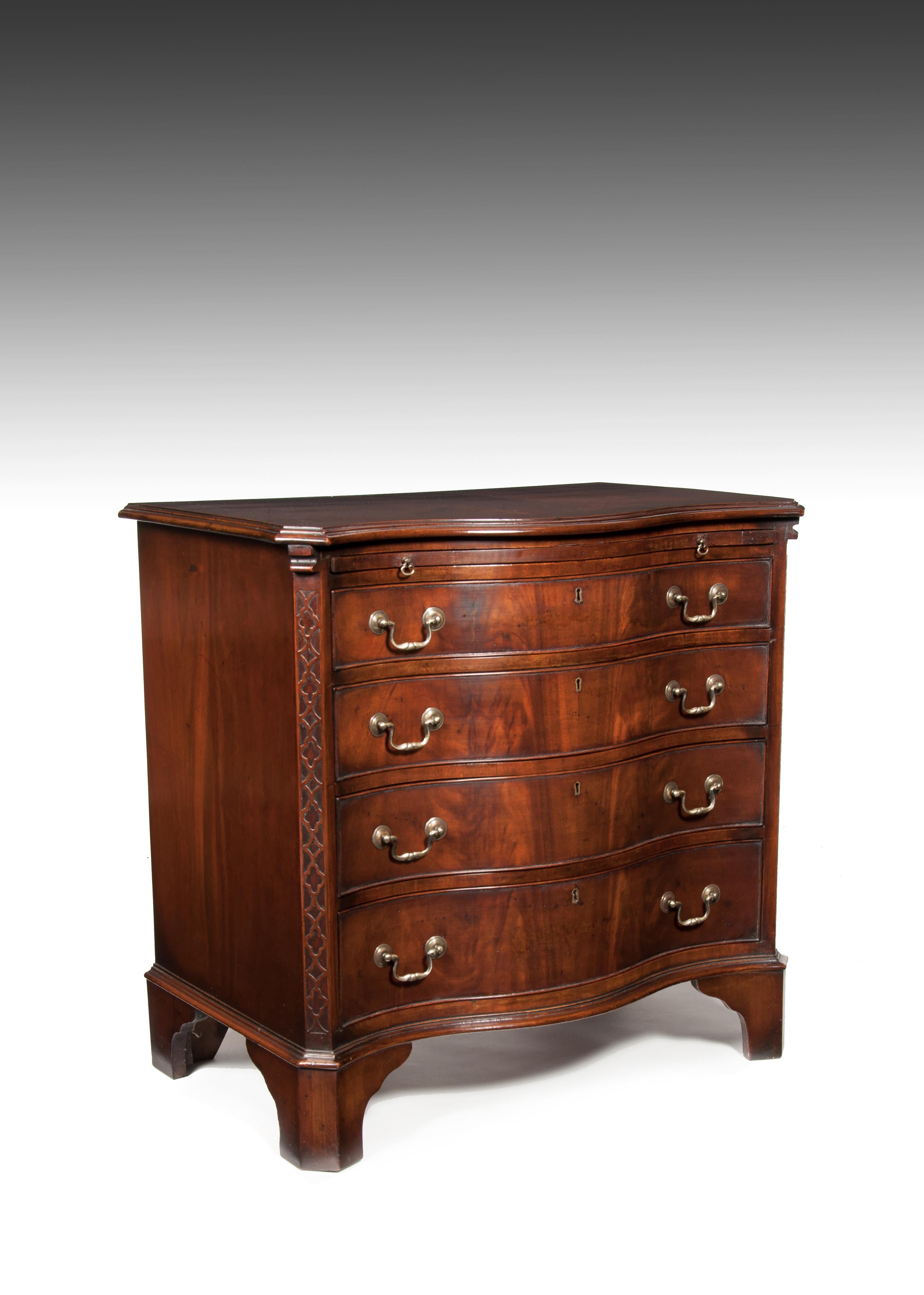 A quality serpentine fronted mahogany chest fo drawers with brushing slide on bracket feet.

English, circa 1900. 

Very well constructed, the serpentine book match veneered top having a cross banded and moulded edge over a pull out brushing