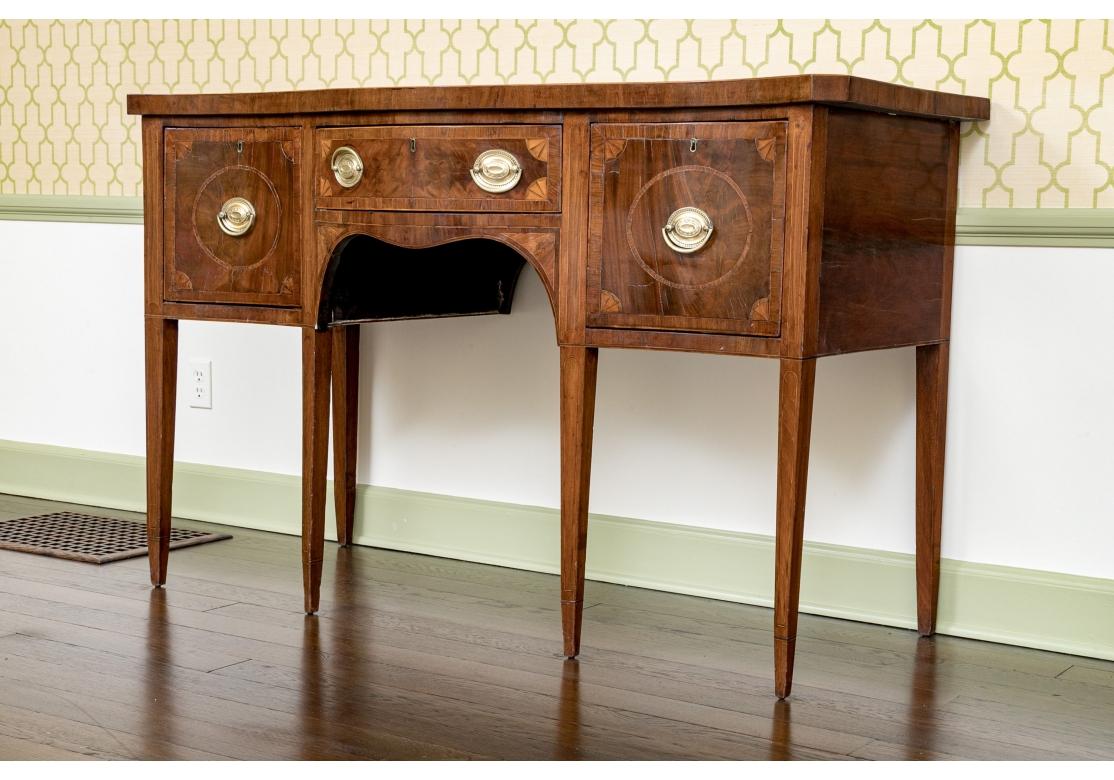 A Tall and Stylish 19th Century Mahogany Sideboard with a  refined Traditional form. The Sideboard has a Banded top and Marquetry decoration pn the drawer fronts with banding and line inlay on both the drawers and doors as well as the tapered legs.