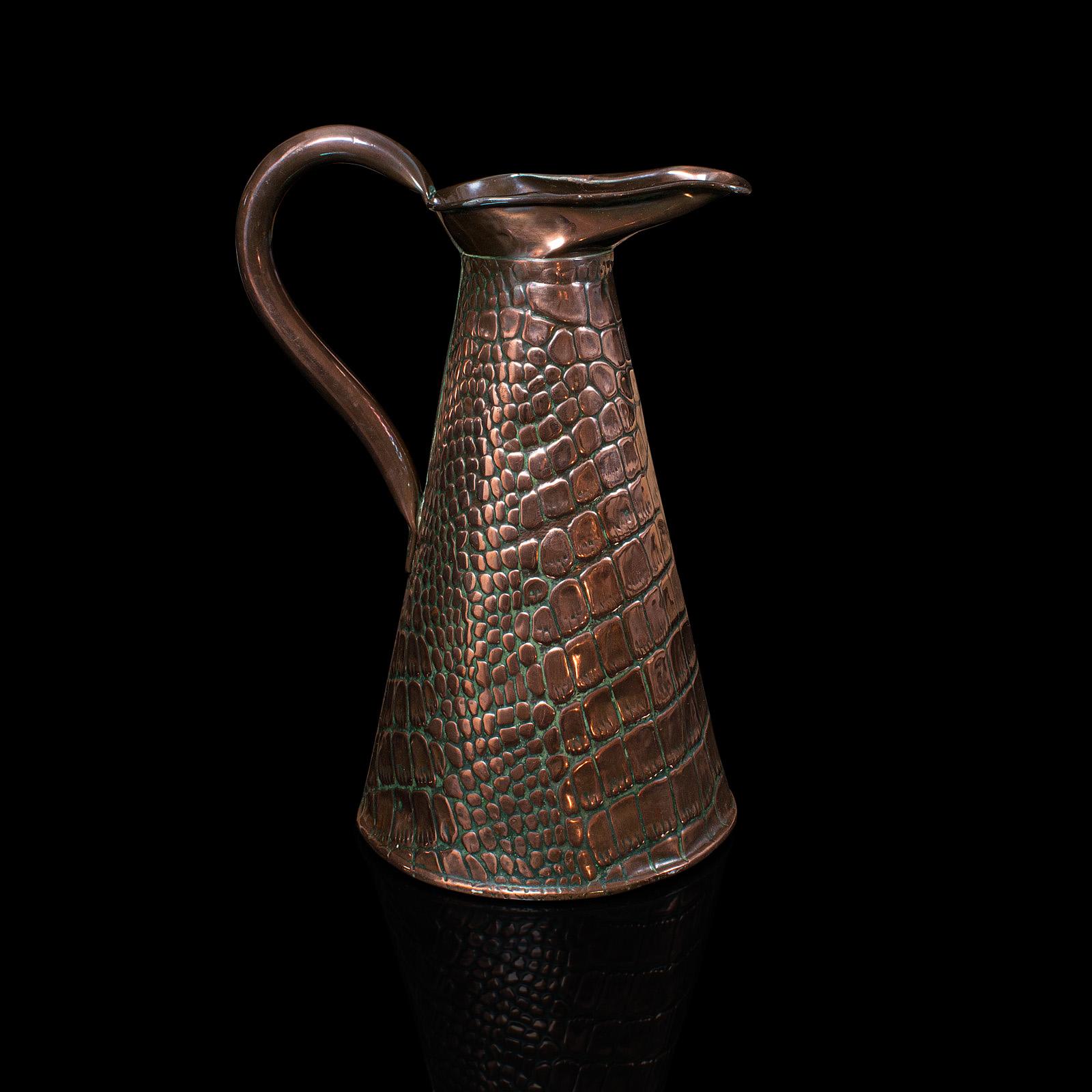 This is an antique serving ewer. An English, copper jug with decorative finish, dating to the Arts and Crafts period, circa 1900.

Distinctive antique ewer with Fine weathering
Displays a desirable aged patina with time-worn impressions to