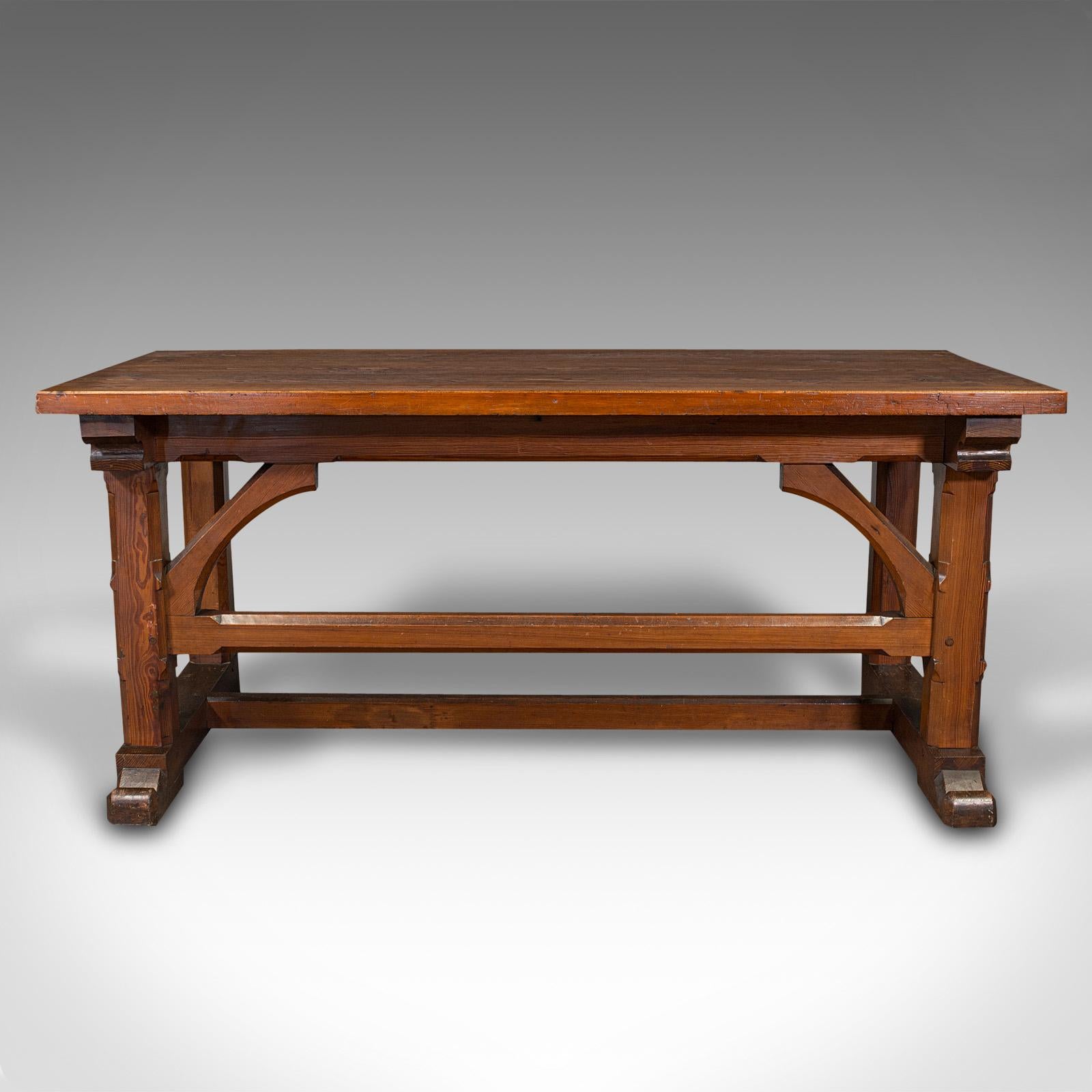 This is an antique serving table. An English, pitch pine hall table with Pugin-esque ecclesiastical taste, dating to the late Victorian period, circa 1880.

Appealing table of generous proportion and Gothic overtones
Displays a desirable aged