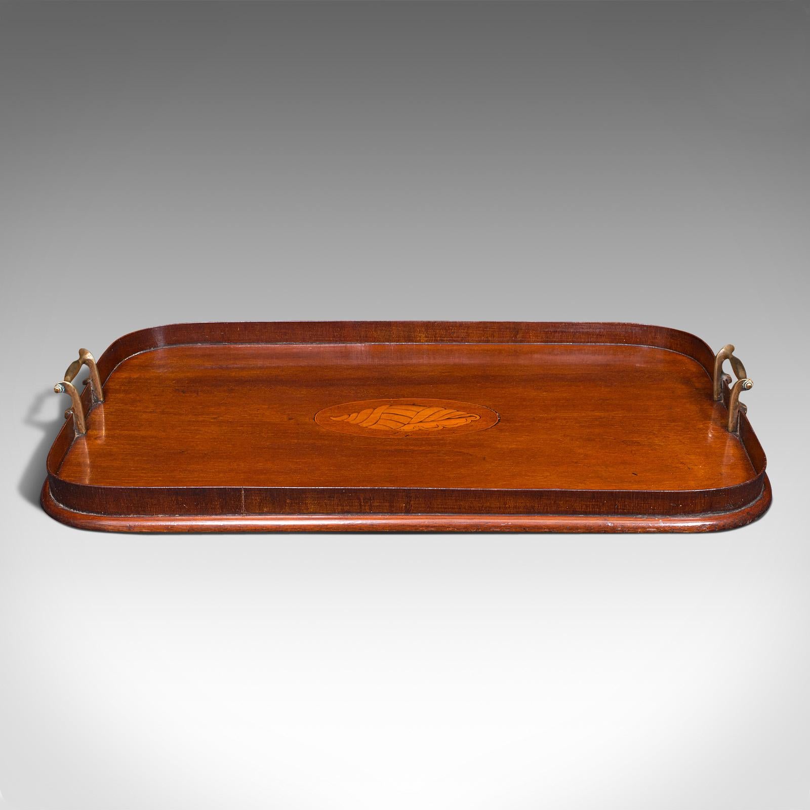 This is an antique serving tray. An English, mahogany and boxwood inlaid butler's afternoon tea tray, dating to the late Victorian period, circa 1900.

Of delightful quality and rich finish
Displays a desirable aged patina throughout
Select