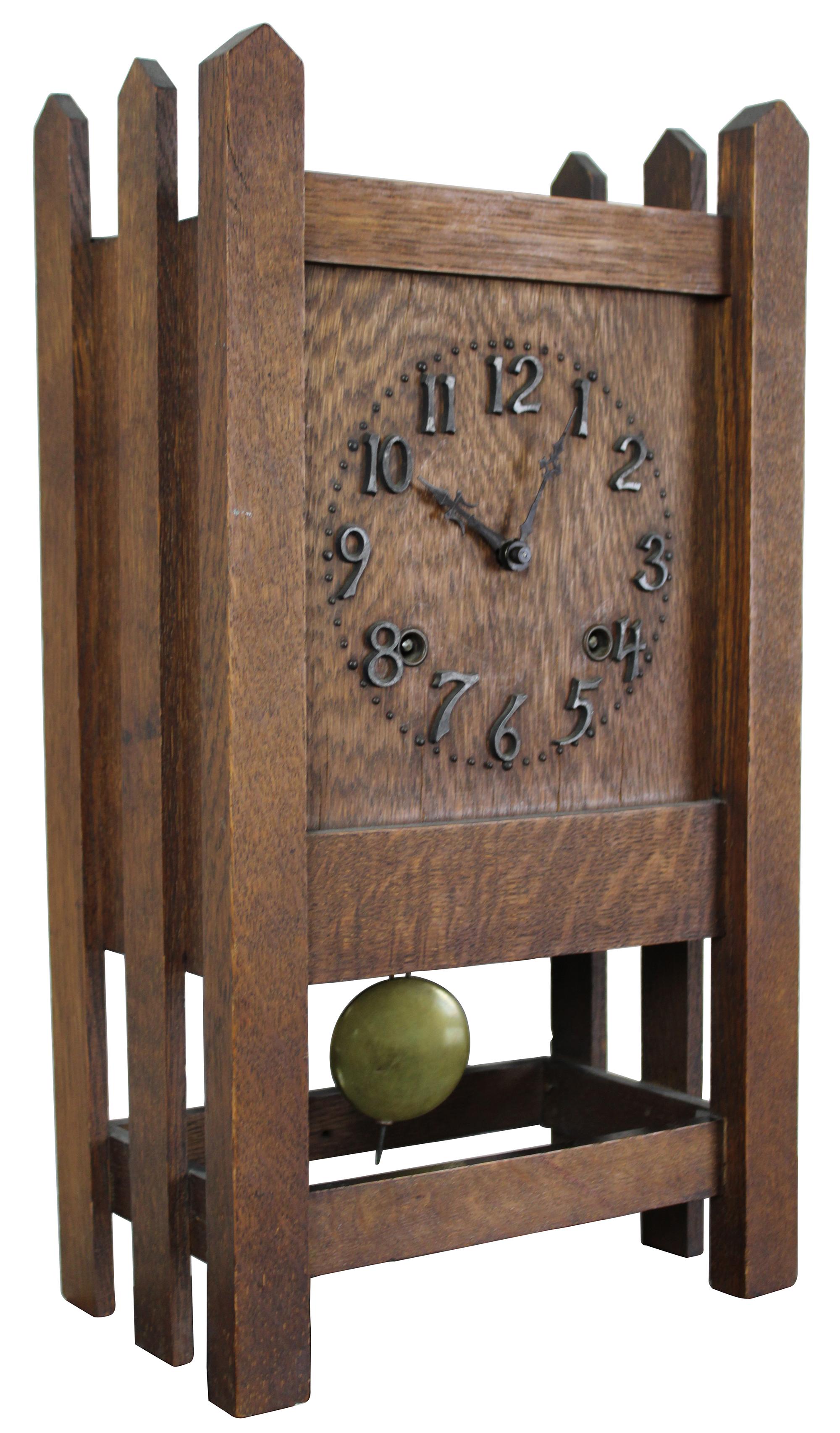 A beautiful mission era 8 day clock by Session Clock Company of Forestville, Connecticut. Made from quartersawn oak with iron mounted numbers and a unique fence post design. Measure: 14