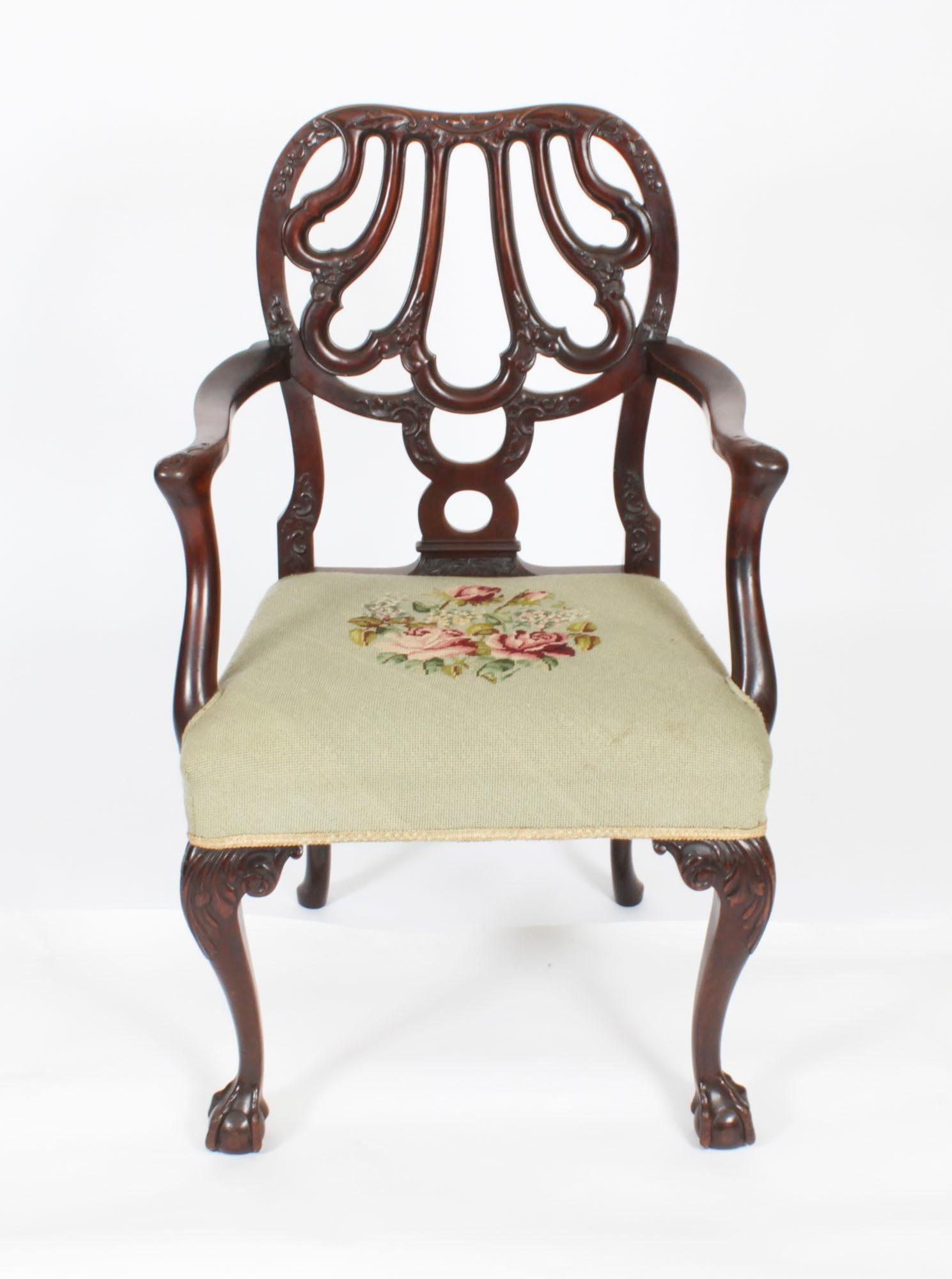 A beautiful and rare antique set of twelve George II Revival carved mahogany dining chairs to a Giles Grendey design by the renowned cabinet makers Robert Strahan, Dublin, Ireland, Circa 1920 in date. 

The chairs have been superbly hand crafted