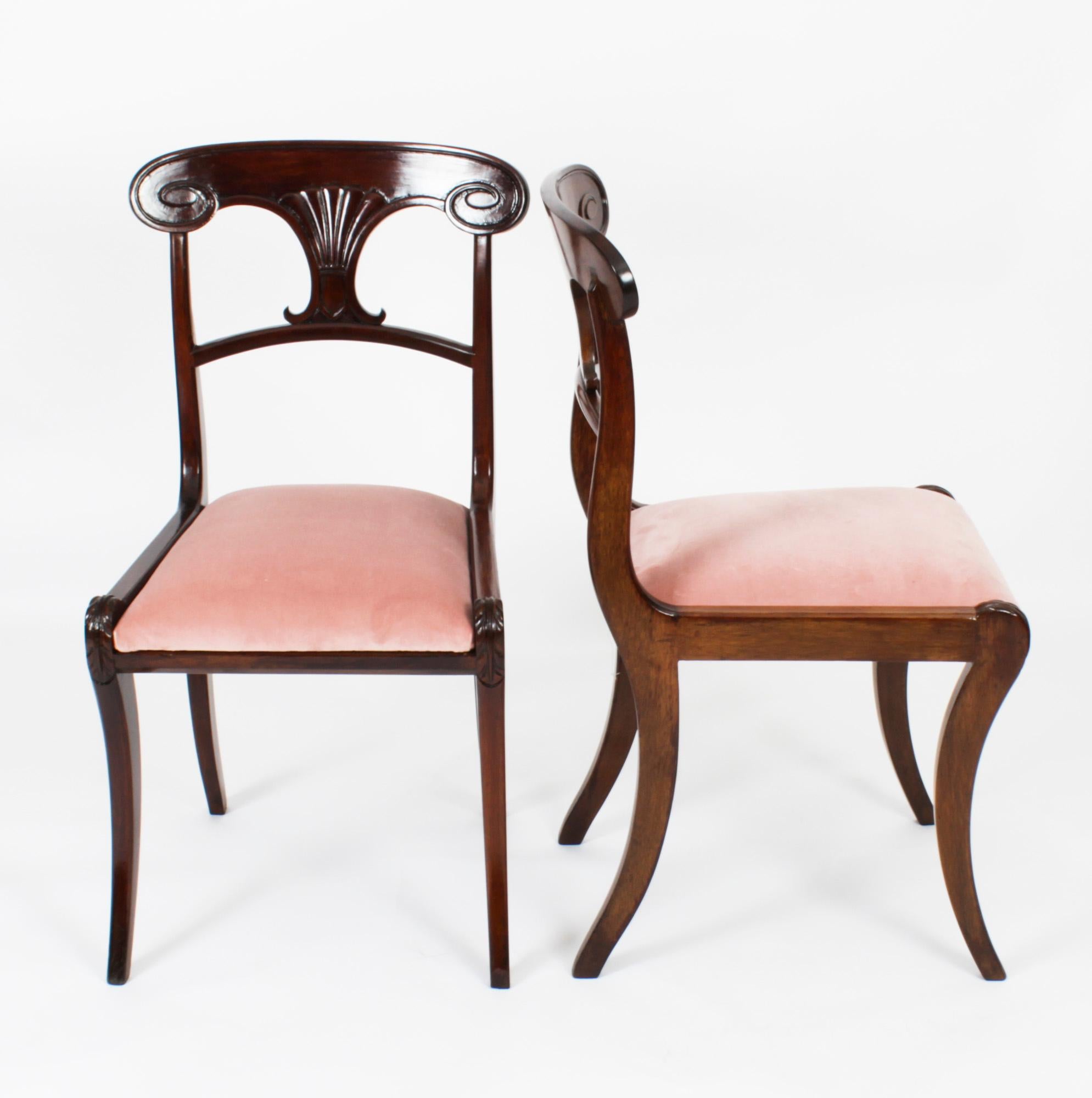 This is a fabulous set of twelve antique English Regency Bar Back dining chairs, Circa 1830 in date.
 
The set comprises twelve chairs masterfully crafted in beautiful solid flame mahogany. They each have elegant scroll carved bar backs with fan