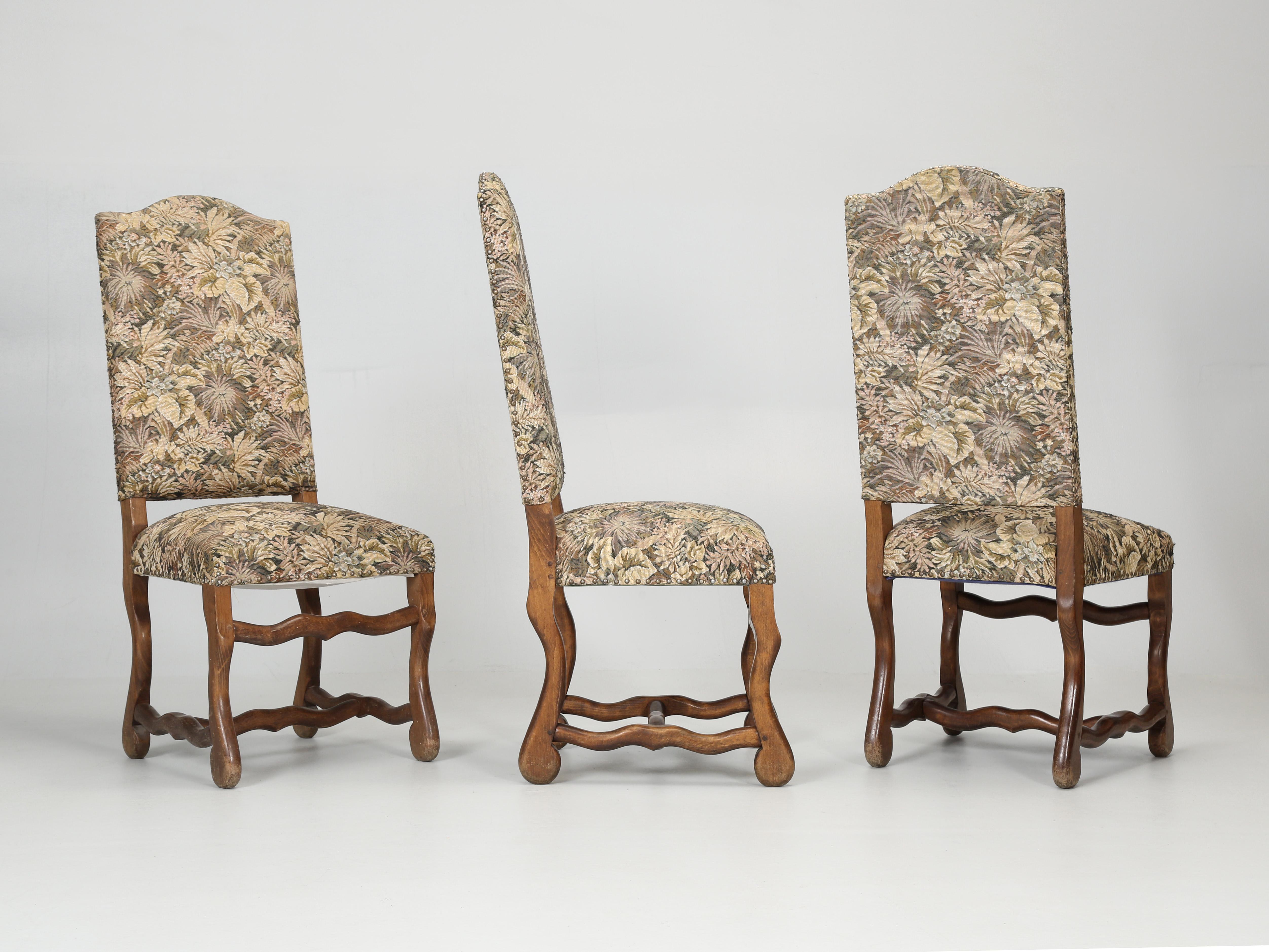 French Os De Mouton Style dining chairs in a most unusual set of (14) side chairs. This rare set of (14) antique French dining chairs were actually hand-carved and assembled with wooden pegs. That said, they are old enough to now require rebuilding