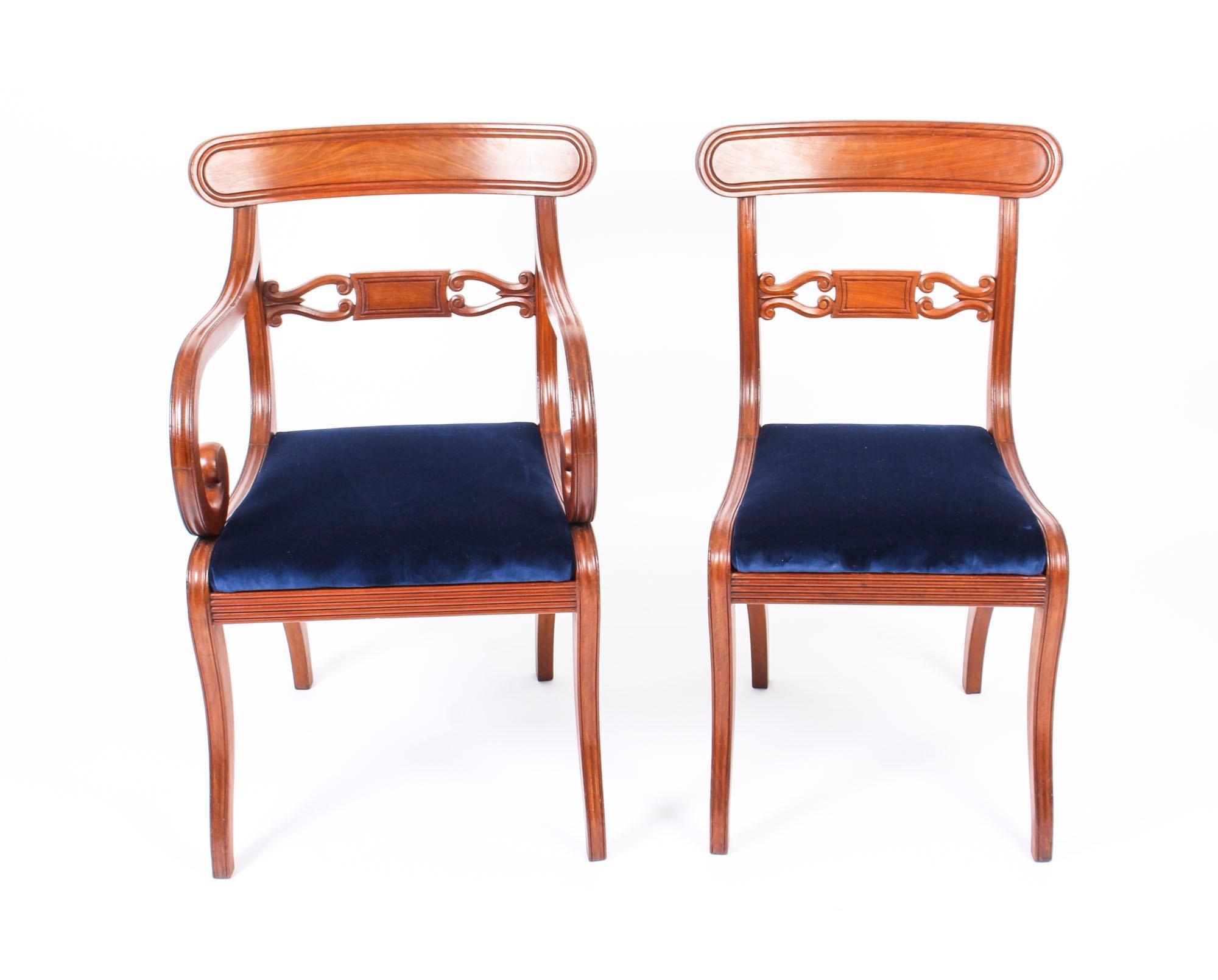 A stunning and rare long set of fourteen antique Regency Period mahogany dining chairs, circa 1820 in date.

The bar back chairs with curved top rails above scrolled horizontal splats. The overstuffed drop in seats above reeded seat rails, they are
