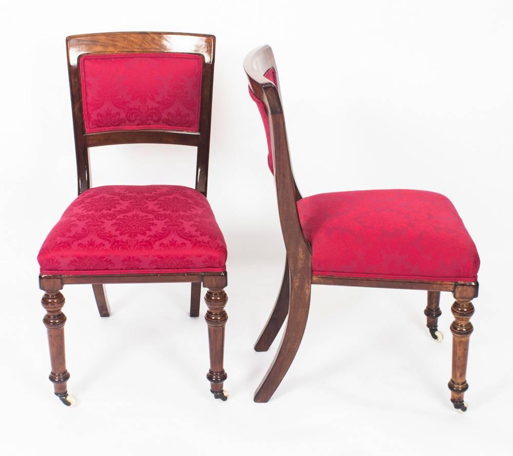 A superb and rare set of fourteen antique Victorian mahogany dining chairs, circa 1870 in date.

With upholstered padded backs and stuff over seats they are raised on elegant turned forelegs that terminate in brass and porcelain castors with sabre