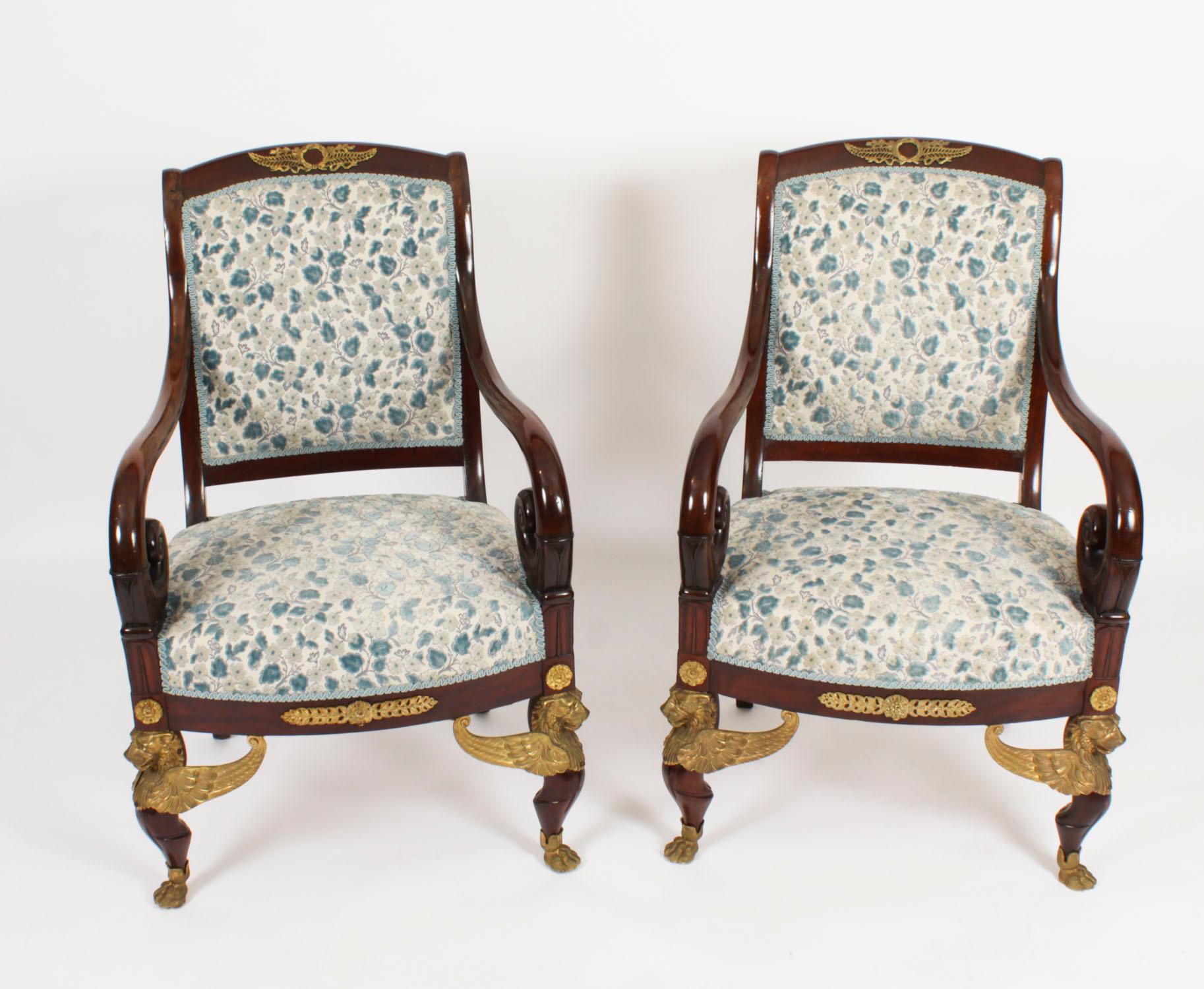 This is a fantastic and highly decorative antique set of four of French ormolu mounted Empire fauteuil armchairs,  circa 1870 in date.
They feature scrolled square padded backs mounted with laurel and anthemion ormolu mounts above stuff-over seats