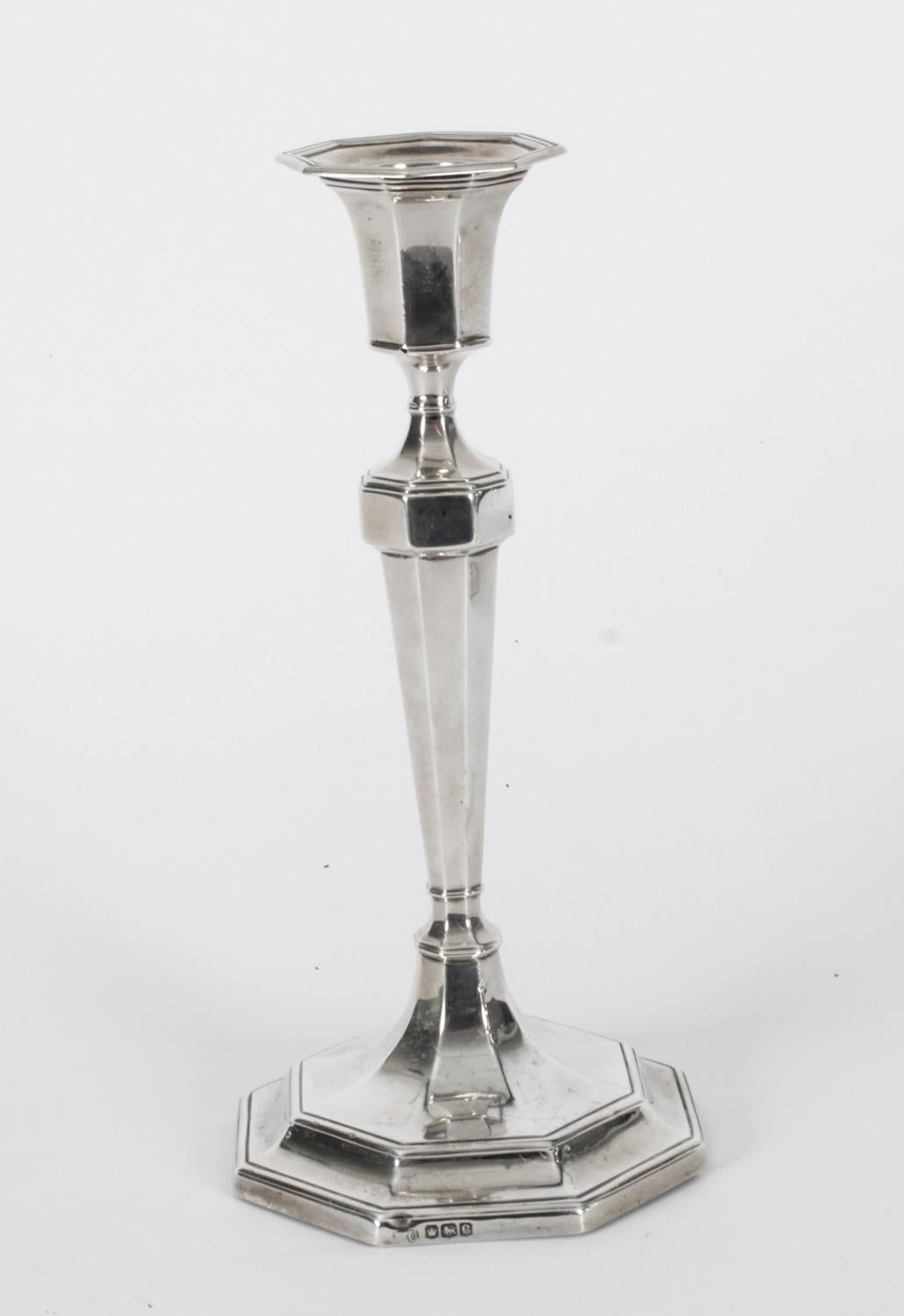 This is an exquisite set of four 1920s silver candlesticks of tapering octagonal form, with separate sconces, on octagonal pedestal bases bearing hallmarks for Sheffield, dated 1920 and the makers mark of the renowned English silversmith Hawkesworth