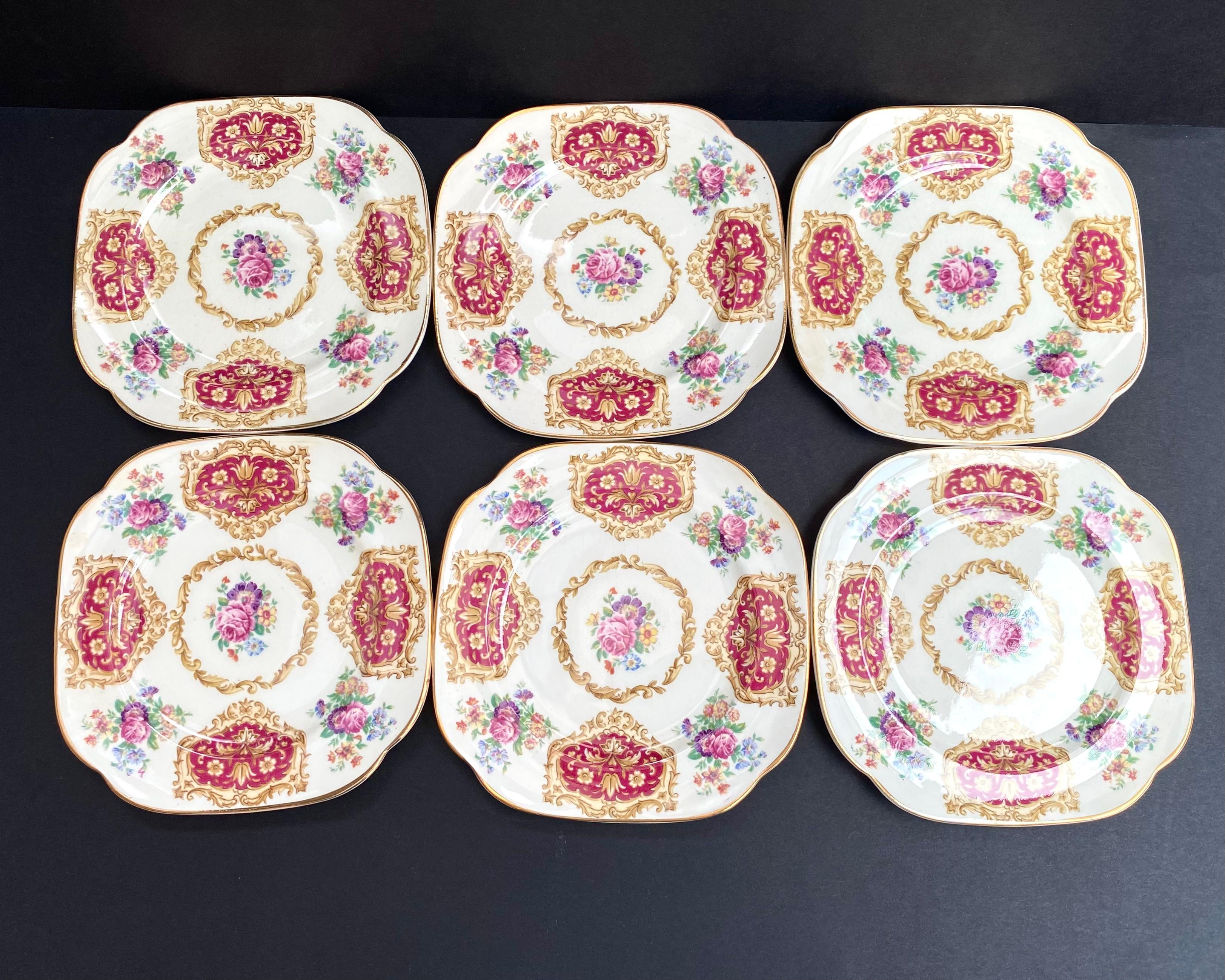 Victorian style Antique Set 6 porcelain dessert plates with craquelure by James Kent Ltd. Langton, England.

Maroon red insets with tan flowers and tan scrolls. Pink rose and blue and purple flower bouquets. Gold trim.

It has the marking ‘James