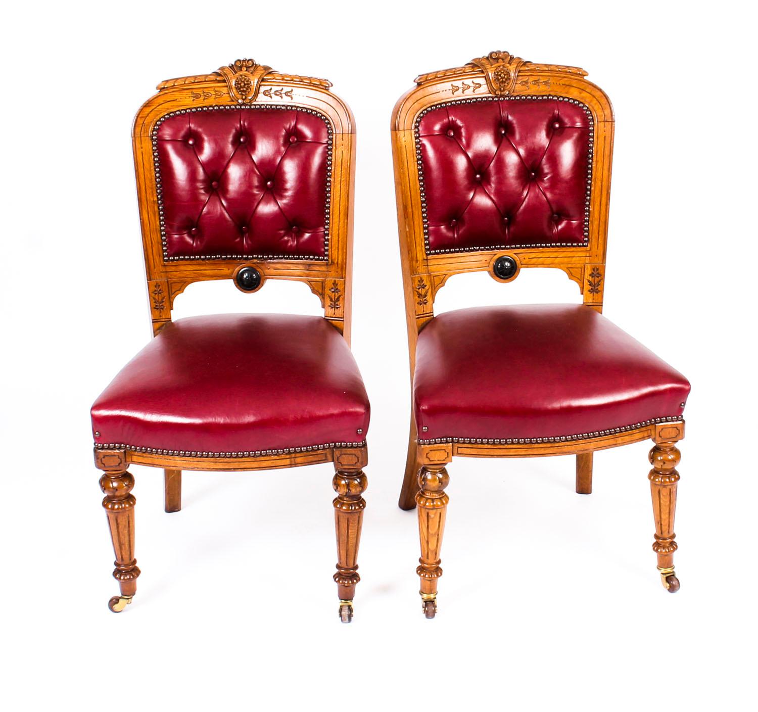 This is a fabulous antique English Victorian set of eight carved oak dining chairs with stunning burgundy leather upholstery circa 1860 in date.

The upholstered backs with beautiful hand carved foliate and anthemion decoration and buttoned back