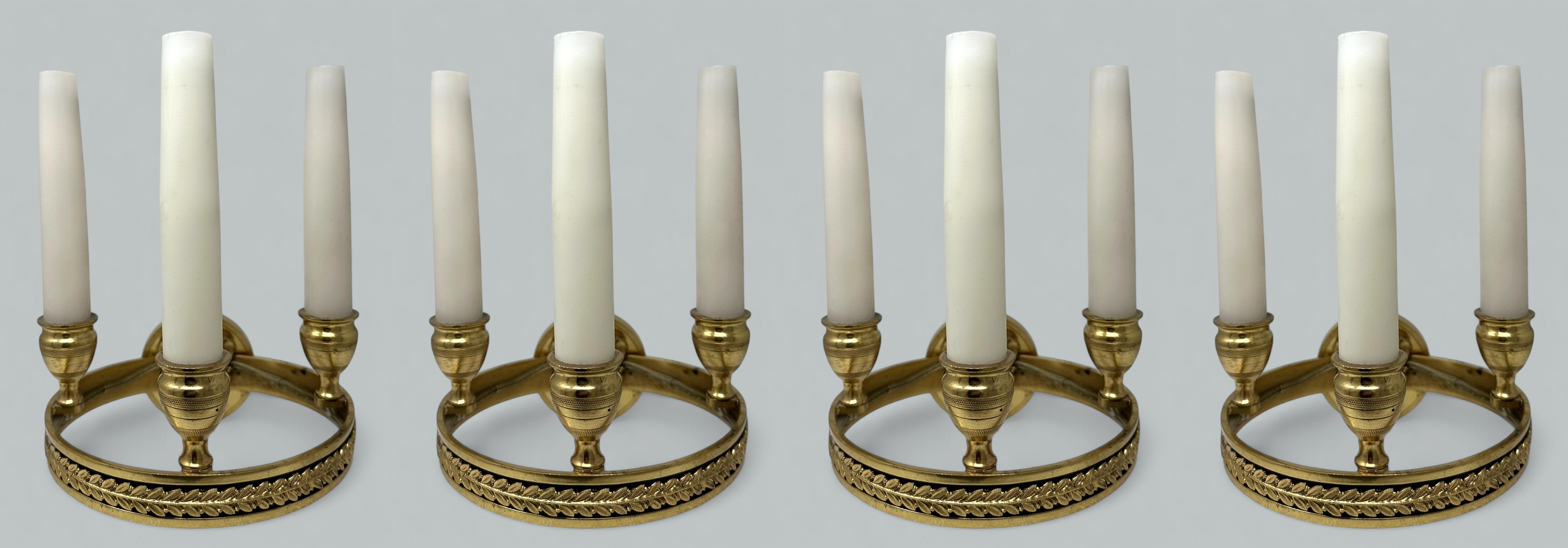 Fine Quality Set of four French Empire Gilt Bronze Three Candle Wall Candle Sconces Lights, of generous proportions, mid to late Nineteenth Century. 

The highly ornate circular support frame issuing from a chisel cast Lions Head supported on a