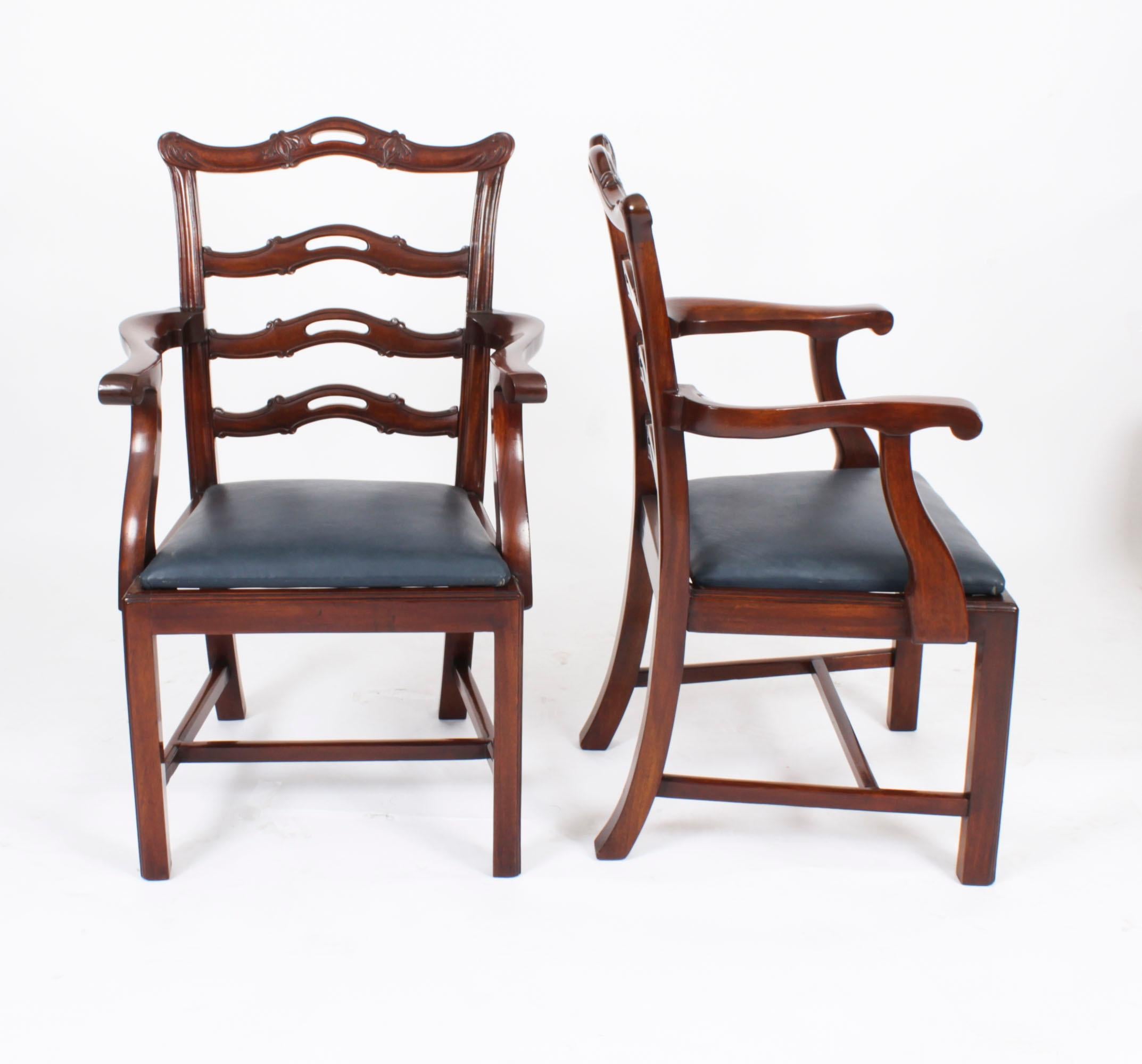 A beautiful Antique set of ten  Chippendale Revival Ladderback dining chairs, comprising eight sidechairs and two armchairs, dating from Circa 1880.

They have been crafted from hand carved solid flame mahogany with drop in seats upholstered in navy
