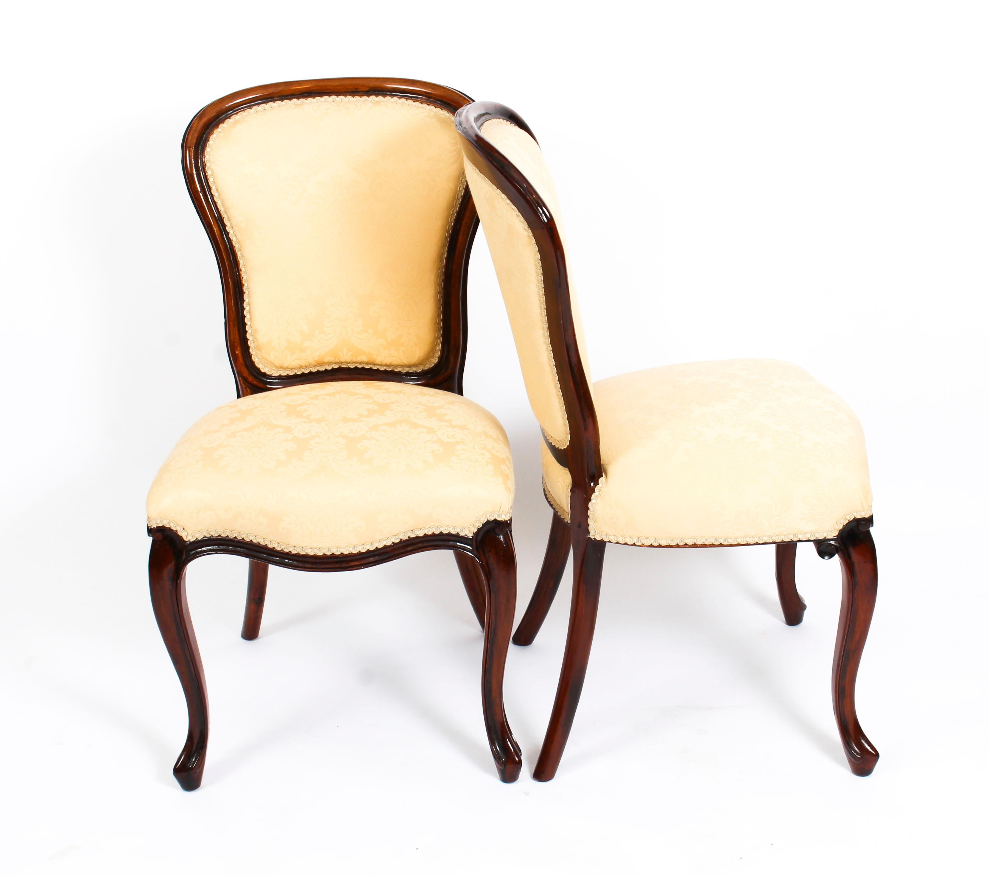 This is a beautiful antique set of ten Louis Revival mahogany dining chairs, dating from the late 19th century.

This set consists of ten side chairs all skillfully carved from solid mahogany and beautifully reupholstered in gold damask.

They