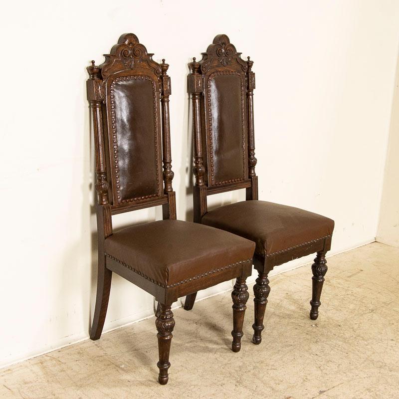 Antique Set of 12 High Back Oak Brown Leather Dining Chairs with Carved Details In Good Condition In Round Top, TX