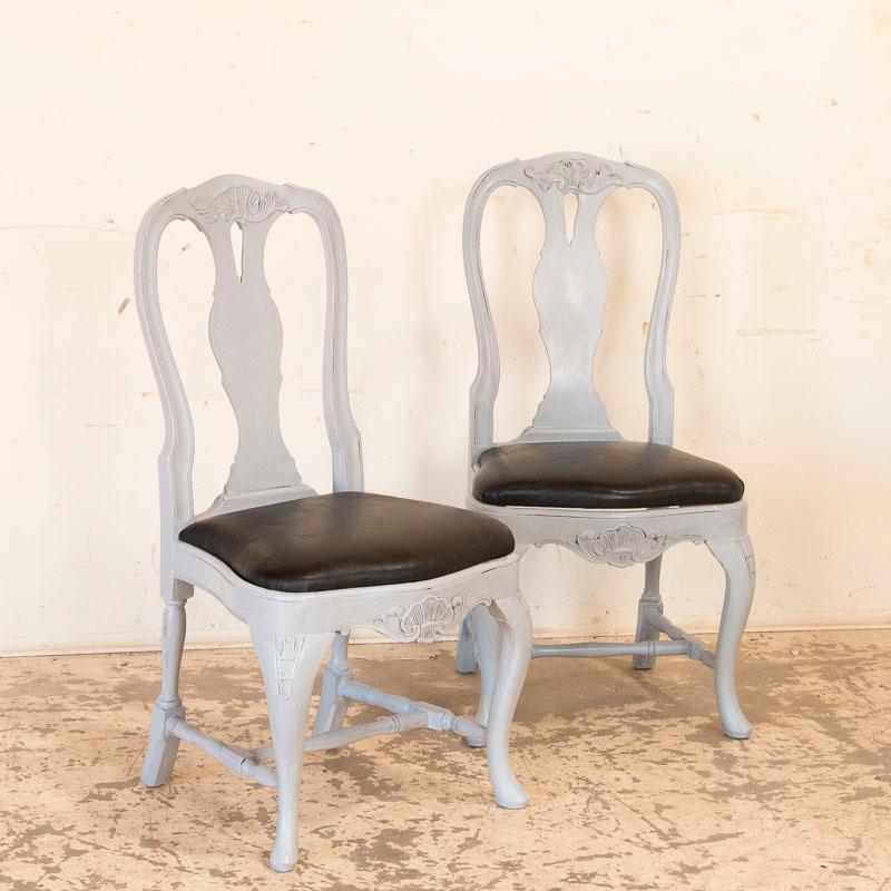 This wonderful set of twelve dining chairs exudes a graceful country charm. While likely from a Swedish farm house, these speak to a more upscale home with a touch of elegance due to the extra elements of carved details and the shapely curves of the