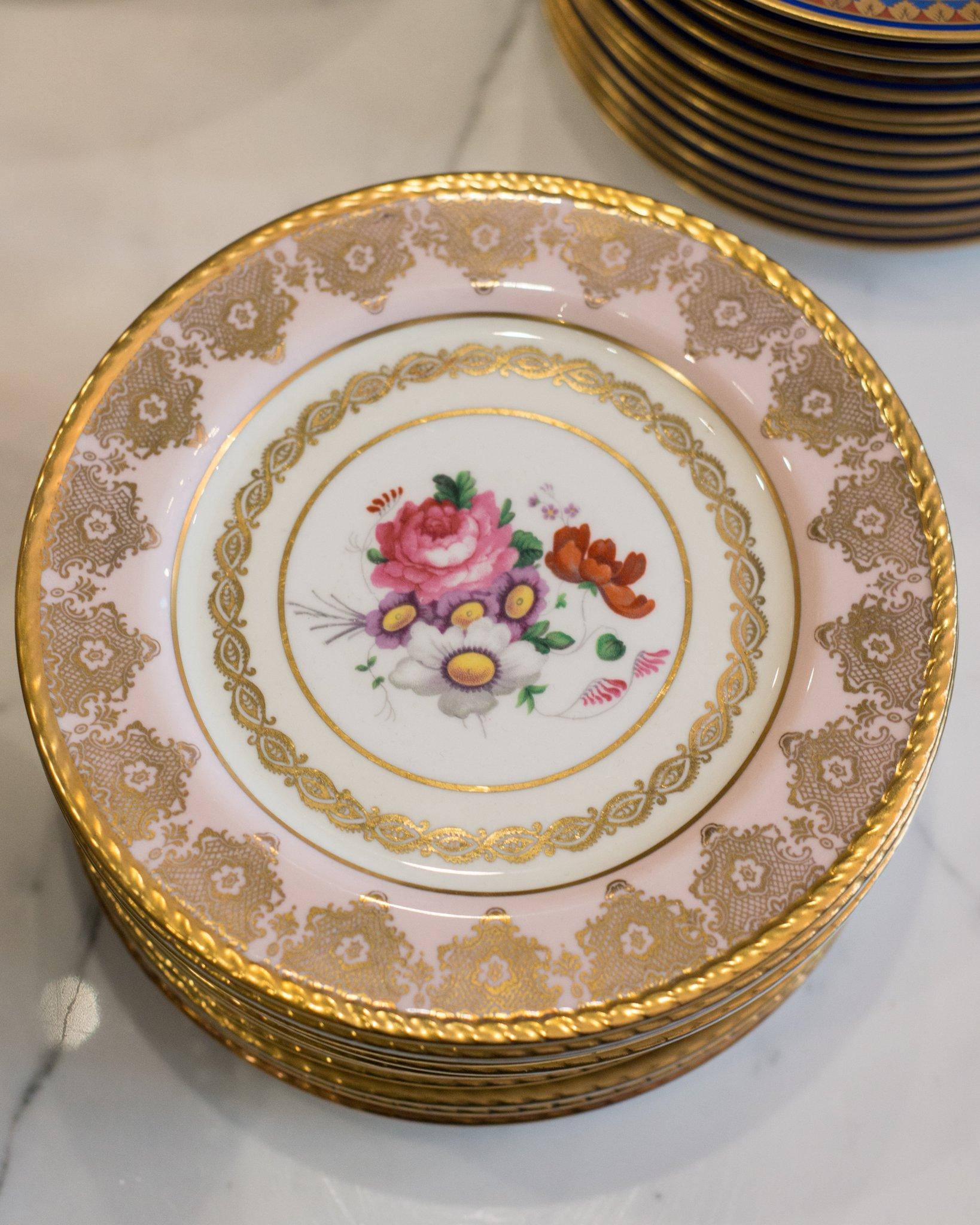 A set of 15 Antique Paragon pink and gold dessert plates, produced in England between 1945-1955. Delicately painted and ornately gilt, the soft pink colour is sure to delight.

The Paragon China Company was a British manufacturer of bone china