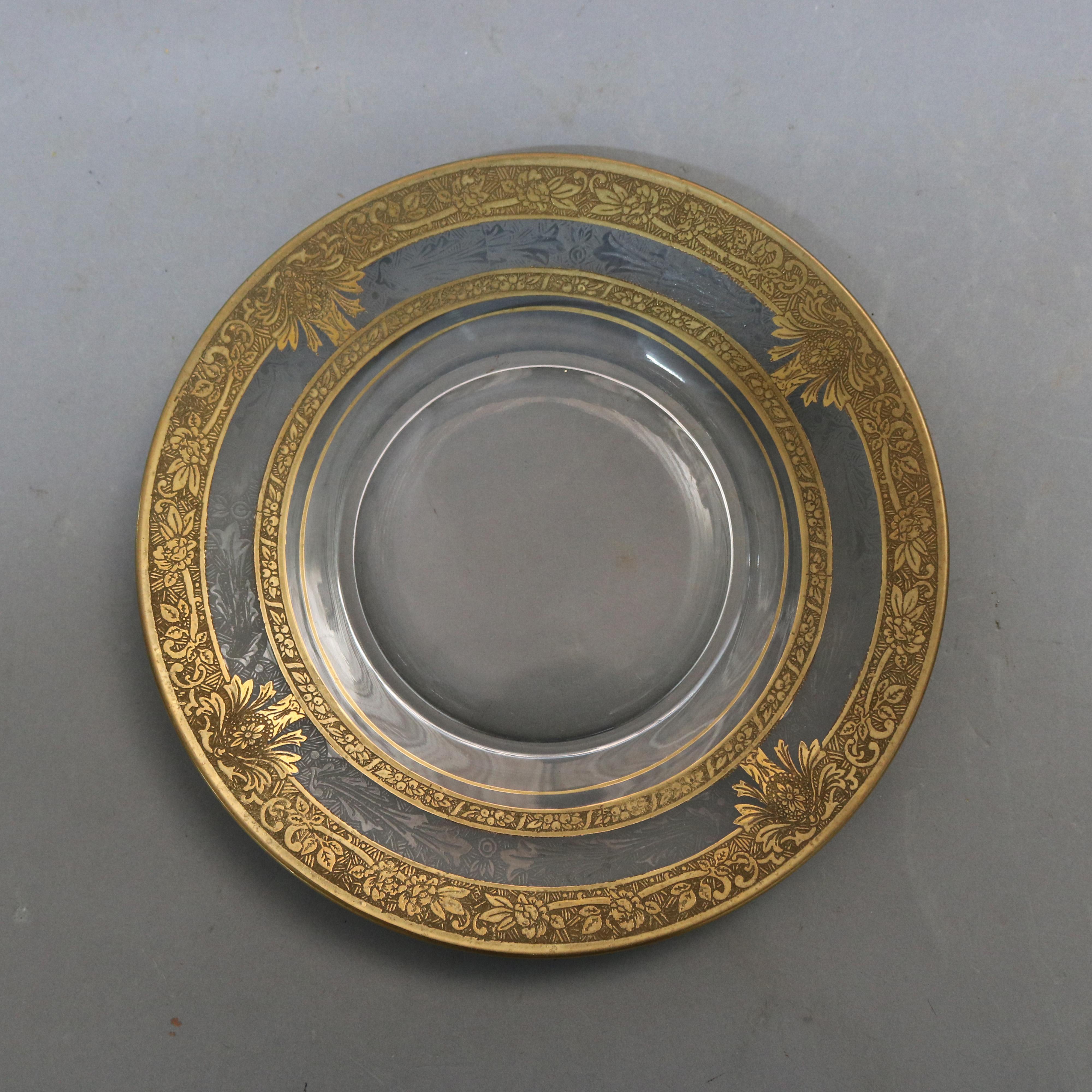 An antique set of 16 dessert plates each offers colorless glass with foliate etched rim with fruit, scroll and foliate gold gilt decoration, 20th century

***DELIVERY NOTICE – Due to COVID-19 we are employing NO-CONTACT PRACTICES in the transfer of