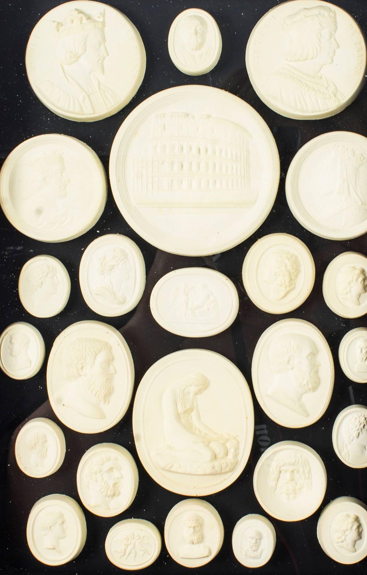 An arrangement of framed plaster Grand Tour intaglios of various sizes dating from the early 19th century.

The intaglios are beautifully framed and mounted on a plush black ground. It consists of 25 circular and oval-shaped plaster intaglios,