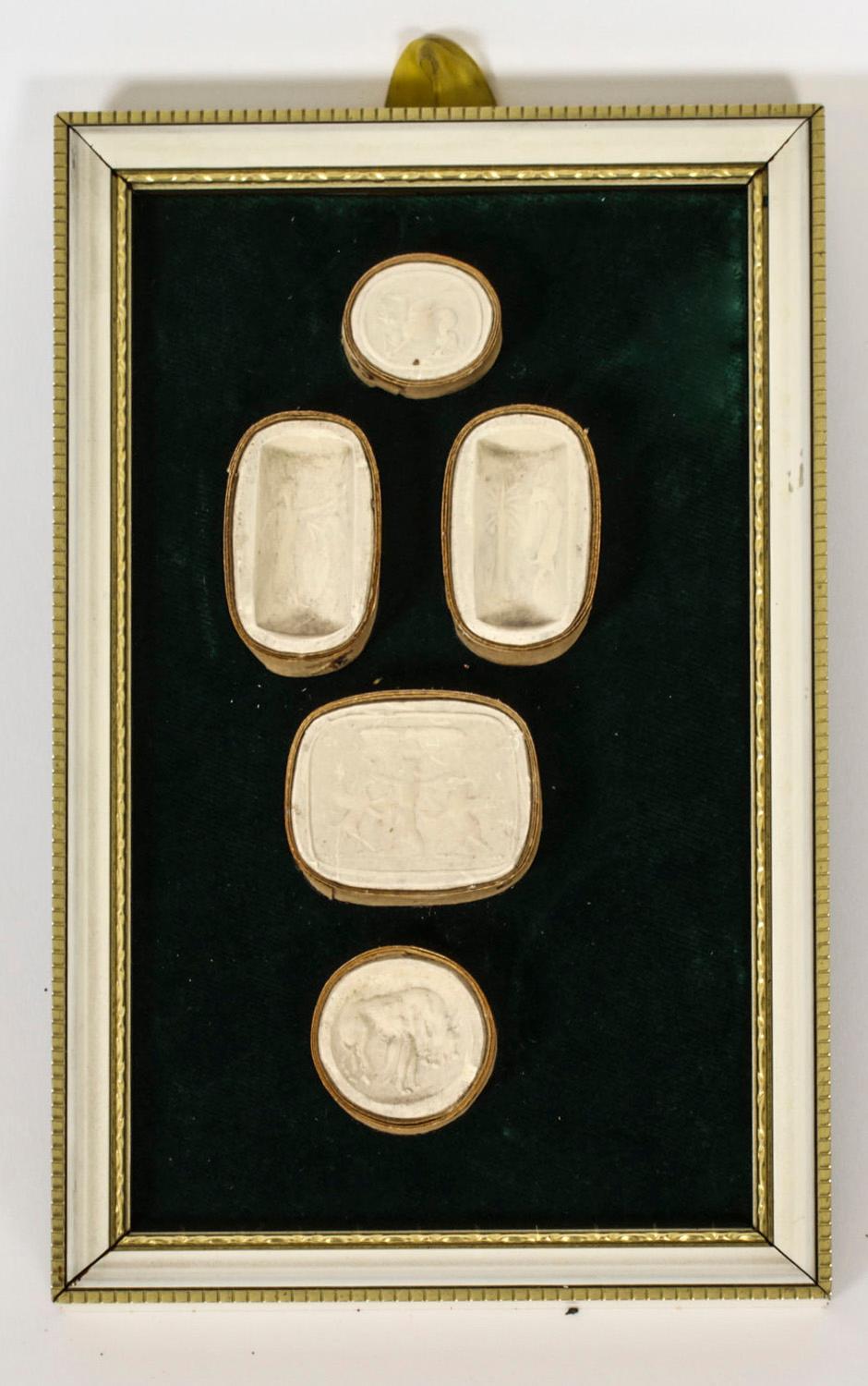 An elegant set of three framed intaglios, enclosing  eighteen plaster Grand Tour Giovanni Liberotti intaglios dating from the early 19th Century.

The large oval shaped plaster intaglios feature classical scenes.

The intaglios are beautifully