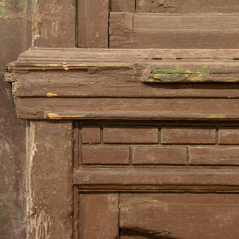 Massive and majestic, this set of 3 doors soar over 12' tall. The green paint is all original, accenting the heavy carved accents that embellish the doors. Please examine the photos closely to understand condition, wear along the bottom, etc. Old