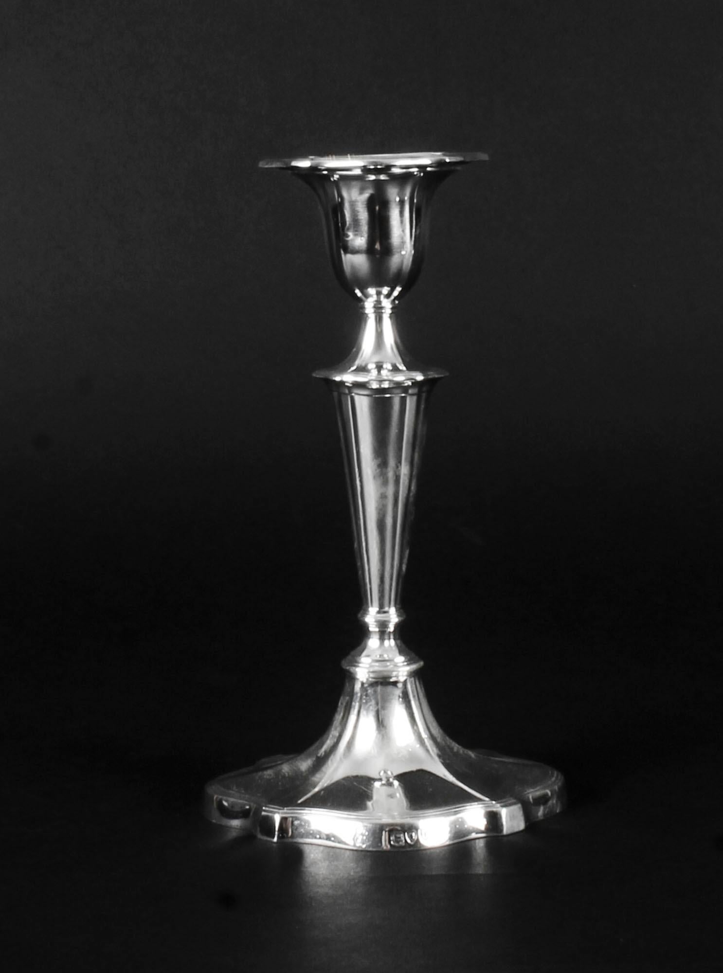 This is a striking set of three antique English Victorian sterling silver candlesticks bearing the makers' marks of the renowned silversmiths William Gibson & John Langman, London, and dating 1895.

Each of these splendid classically style