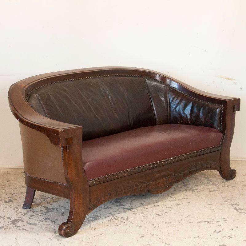 Remeniscent of a time when men would go to smoking lounges for private conversation, this set of vintage leather sofa and club chairs would set the scene there. The aged leather has taken on a purplish hue, with the seat backs darker than the seats.