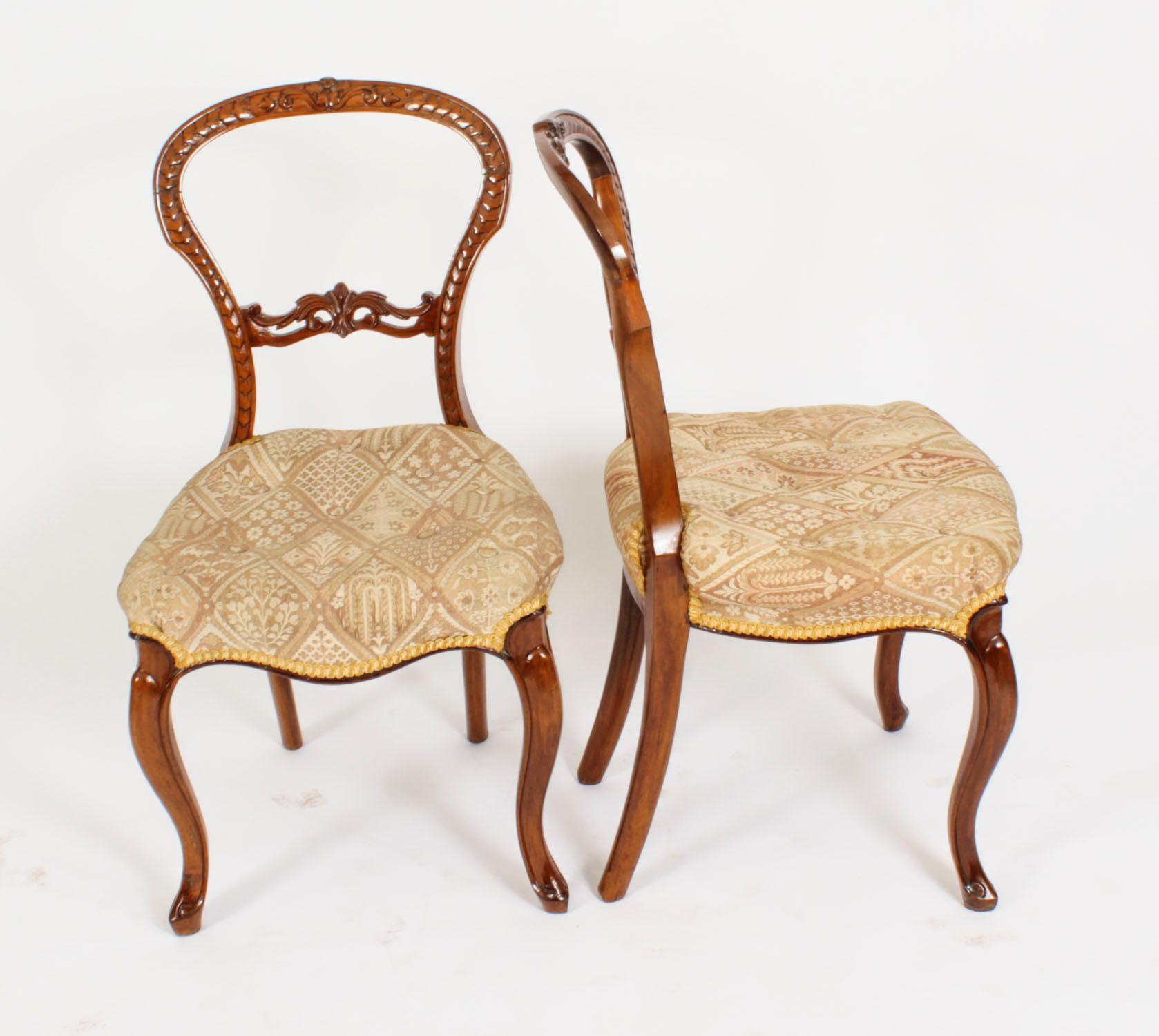 This is a beautiful set of six English antique Victorian walnut dining chairs, circa 1860 in date.

They have striking carved solid walnut backs and mid rails and are raised on elegant cabriole legs. The seats are upholstered in a sumptuous cream