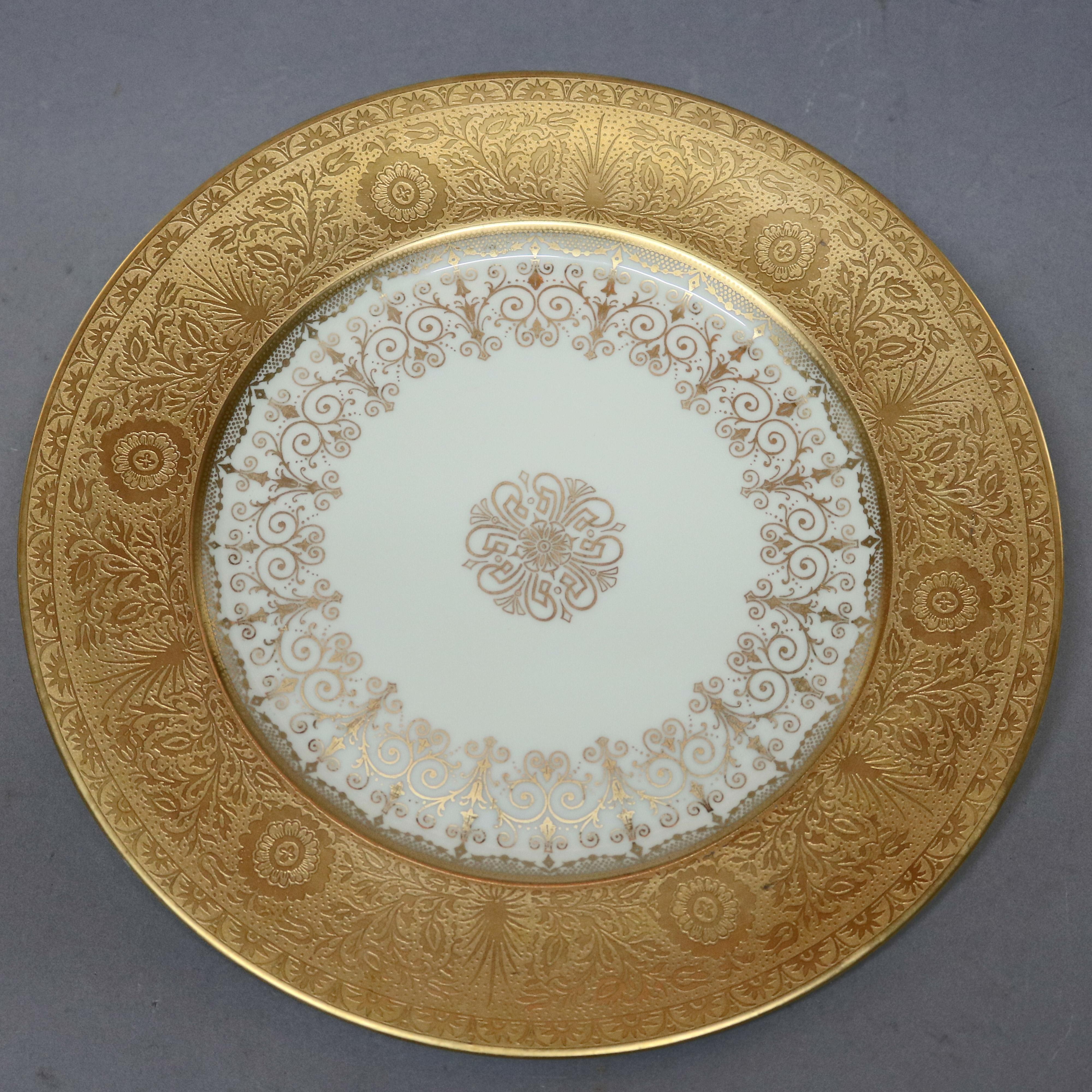 An antique set of eight Selb Bavaria Heinrich porcelain dinner plates offer gilt rims with scroll and foliate decoration, well with scroll gilt filigree, en verso stamp as photographed, circa 1900.

Measures - .75