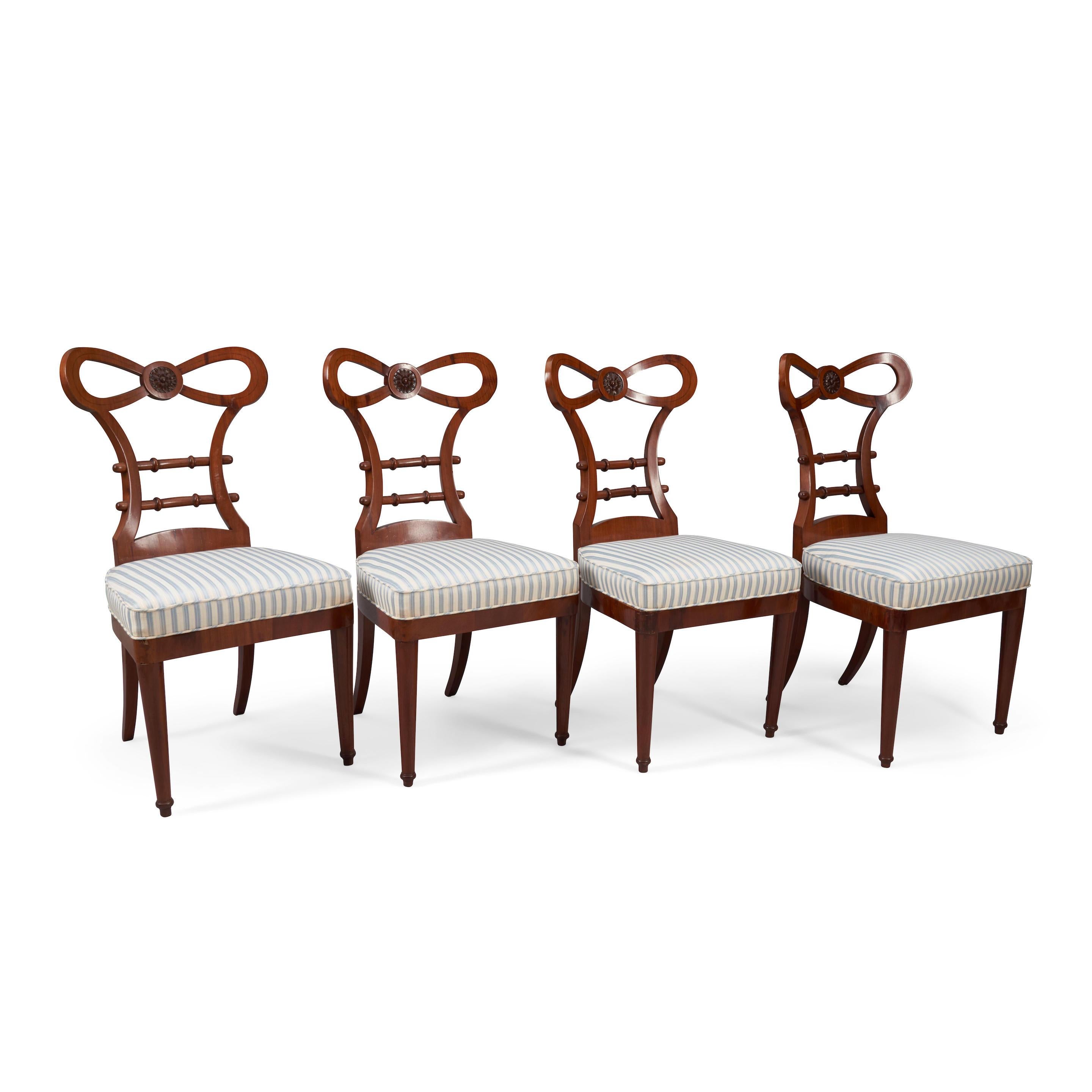 SET OF FOUR BIEDERMEIER WALNUT SIDE CHAIRS
• Germany or Austria
• 19th century
• The bow forms the top rail with central paterae
• The open back with turned horizontal stiles
• Upholstered slip-in seat above turned tapered legs in the front and