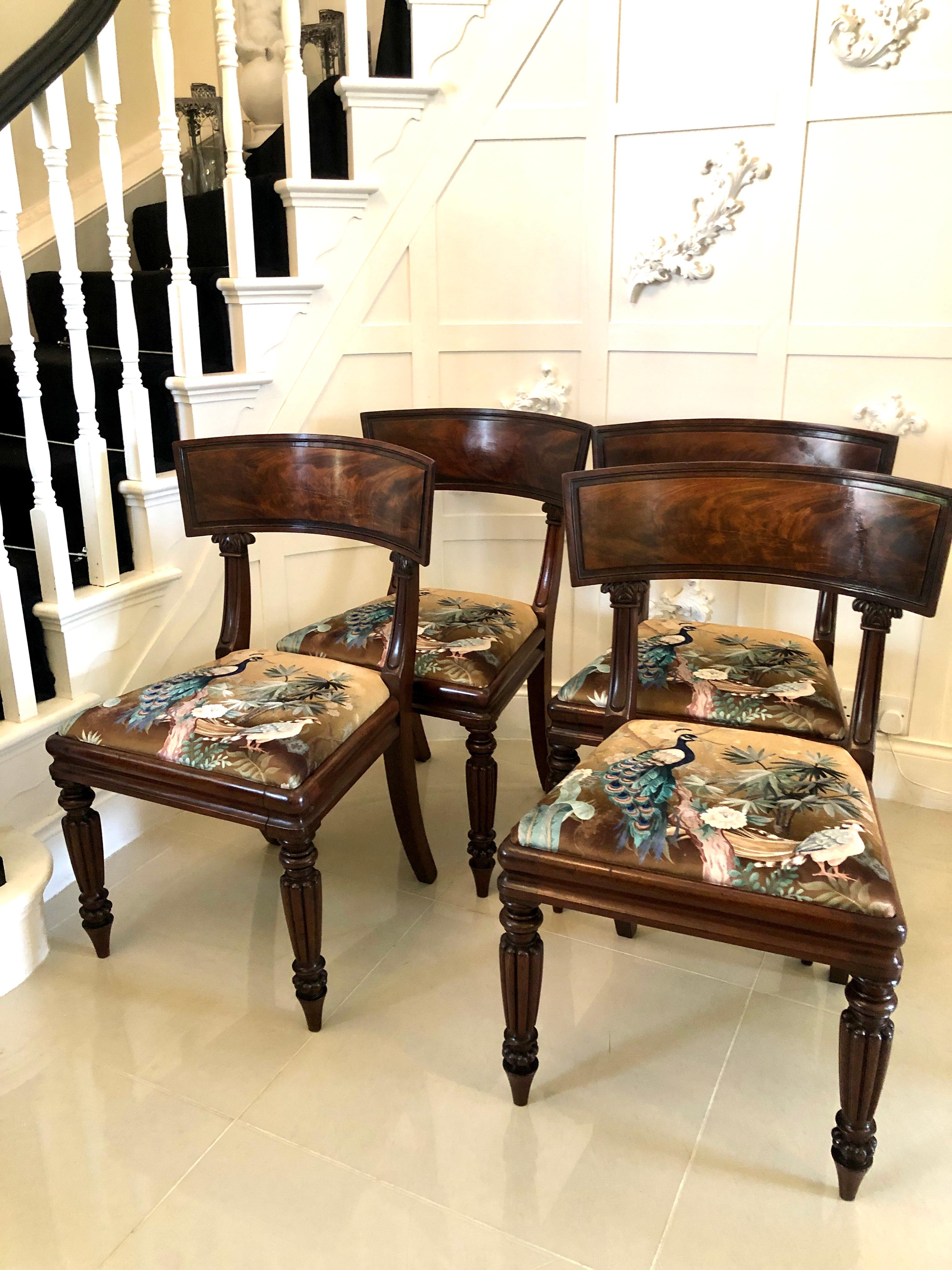 Fine quality antique set of four mahogany Regency library chairs having a quality shaped reeded mahogany top rail supported by carved and reeded uprights, newly reupholstered drop in seats in a beautiful quality fabric, shaped mahogany frieze and