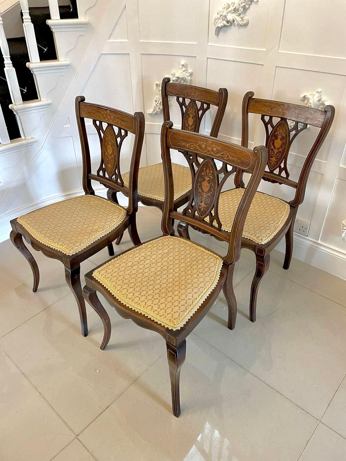 Antique set of four Edwardian rosewood inlaid dining chairs having a delightful inlaid top rail and inlaid shaped centre splats. The chairs stand on shaped cabriole legs to the front united by an attractive shaped frieze, out swept back legs. They