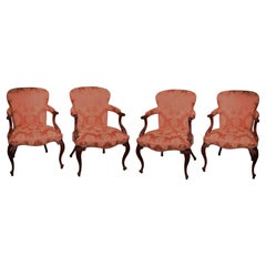Antique set of four Hepplewhite period carved mahogany stuffed back armchairs