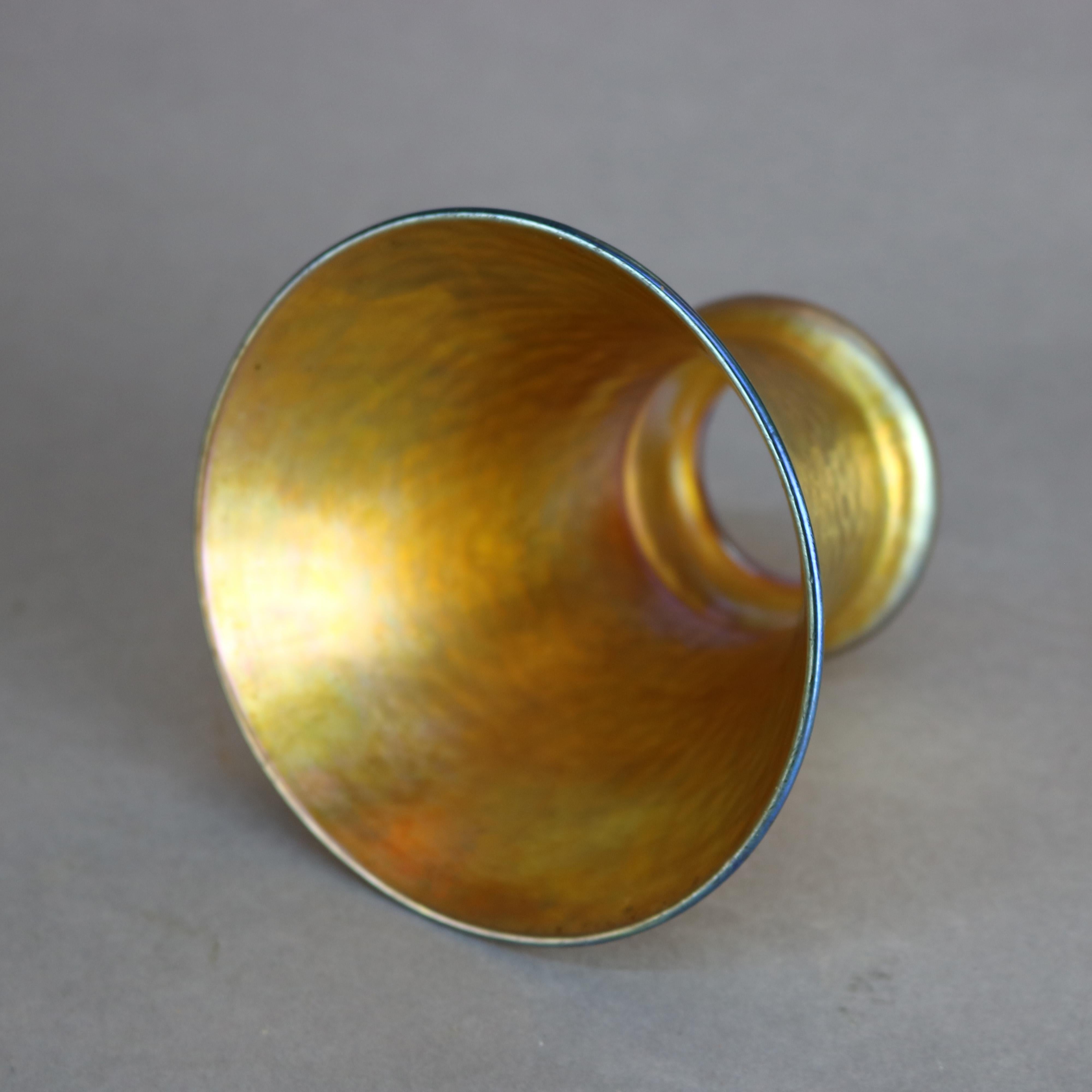 An antique set of four art glass shades by Quezal offer bell form with the appearance of a hammered texture, signed on rims as photographed, c1920

Measures: 4.75