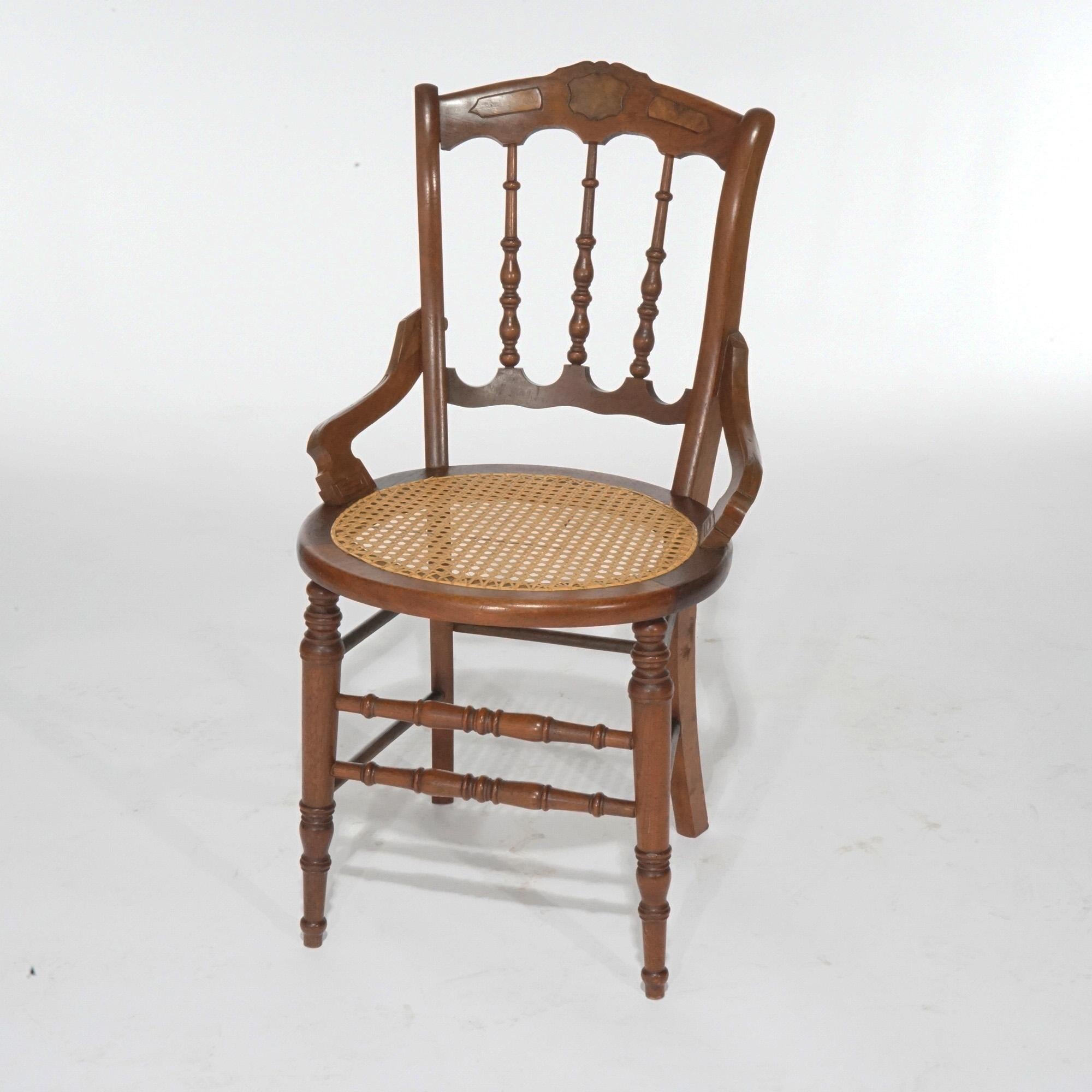 An antique set of four Victorian dining chairs offer walnut construction with shaped rail having burl insets over cane seats and raised on turned legs, c1890.

Measures- 34.5''H x 19''W x 21.5''D.