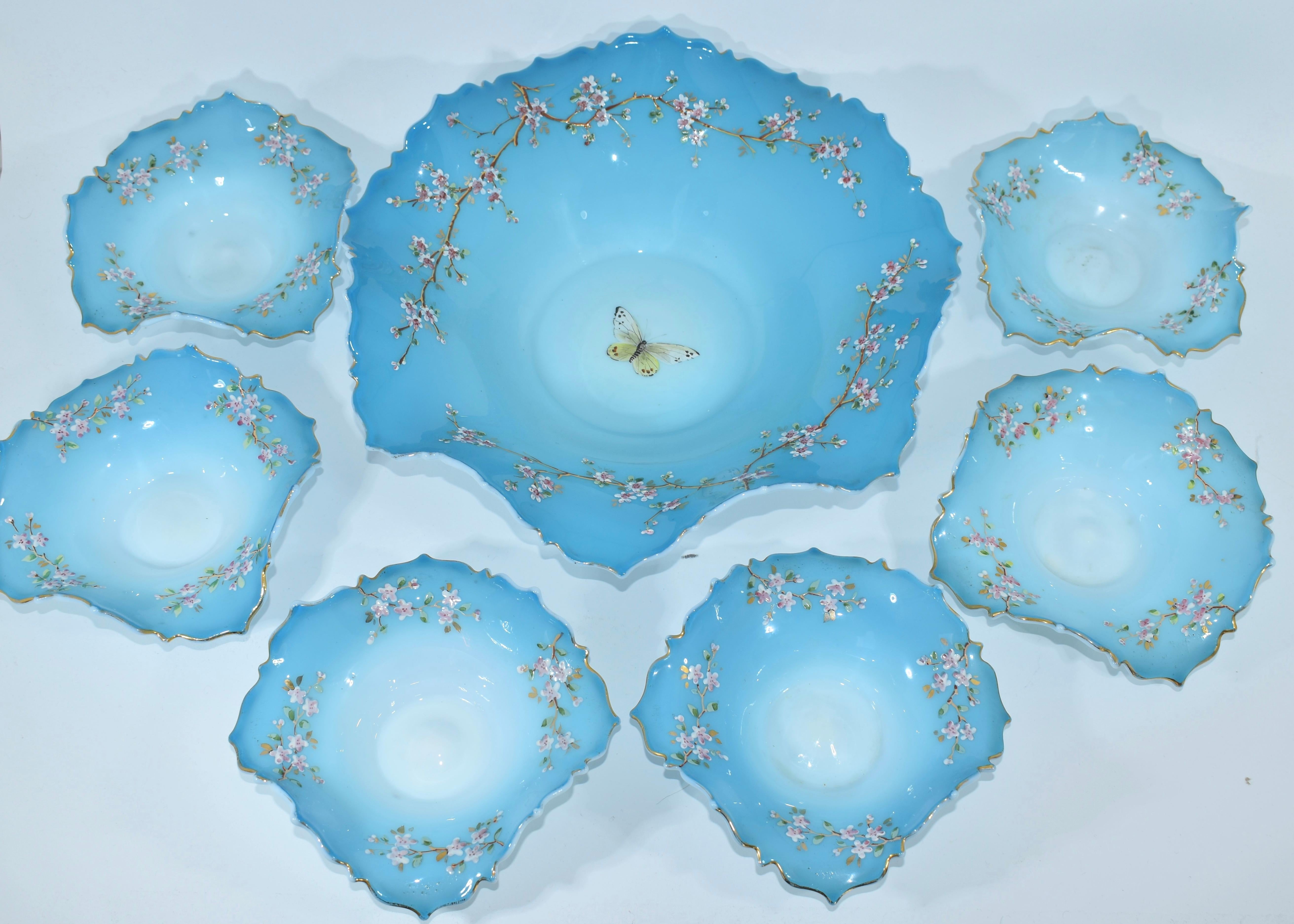 An elegant plate set, a large plate and 6 smaller matching plates

made of two-tone opaline glass, milky white and turquoise, with beautiful wavy edges and colorful enamel decoration

fine example of high quality French opaline glass manufacture