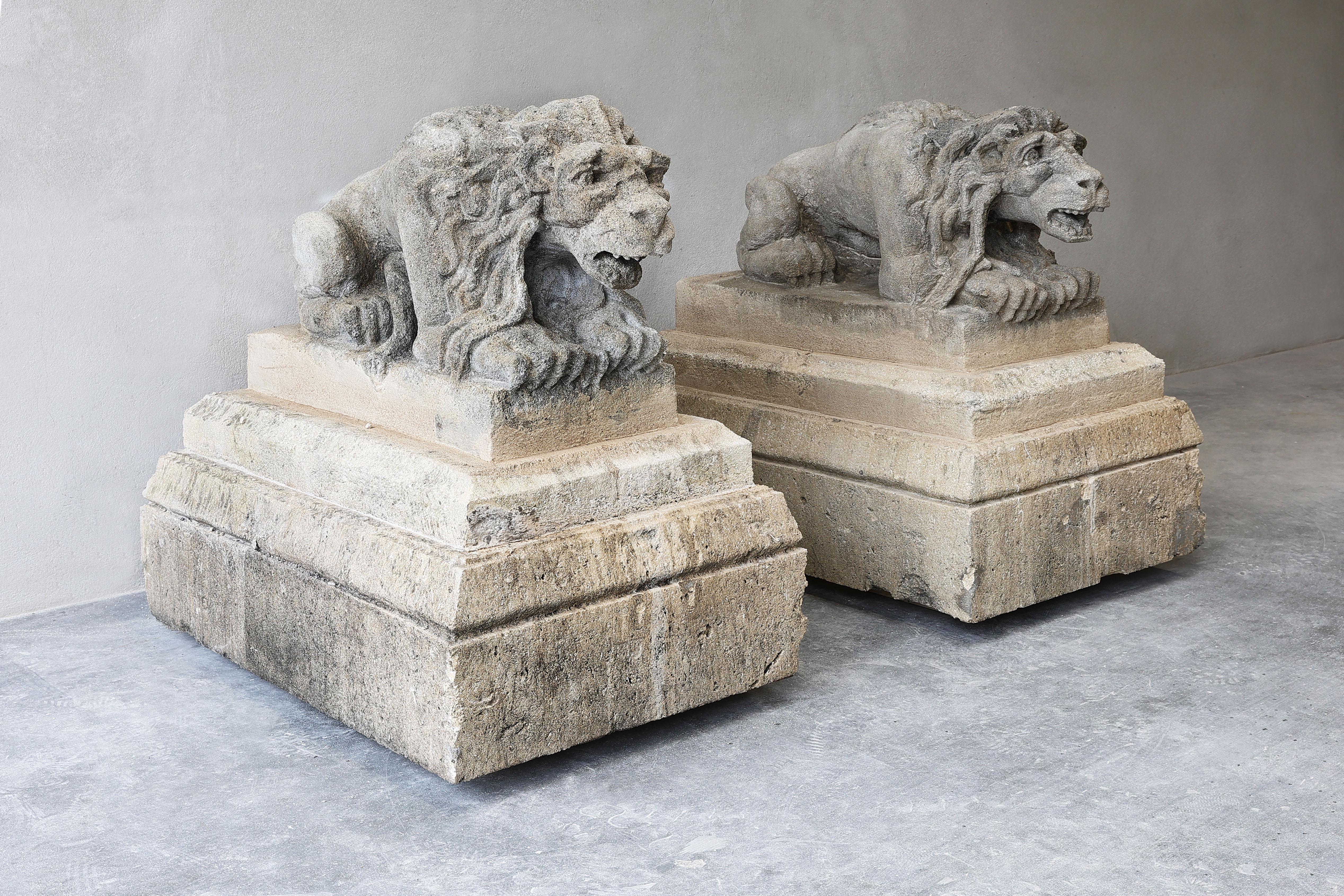 A very nice antique set of two lions on a pedestal of French limestone. These statues are dated from the 19th century.