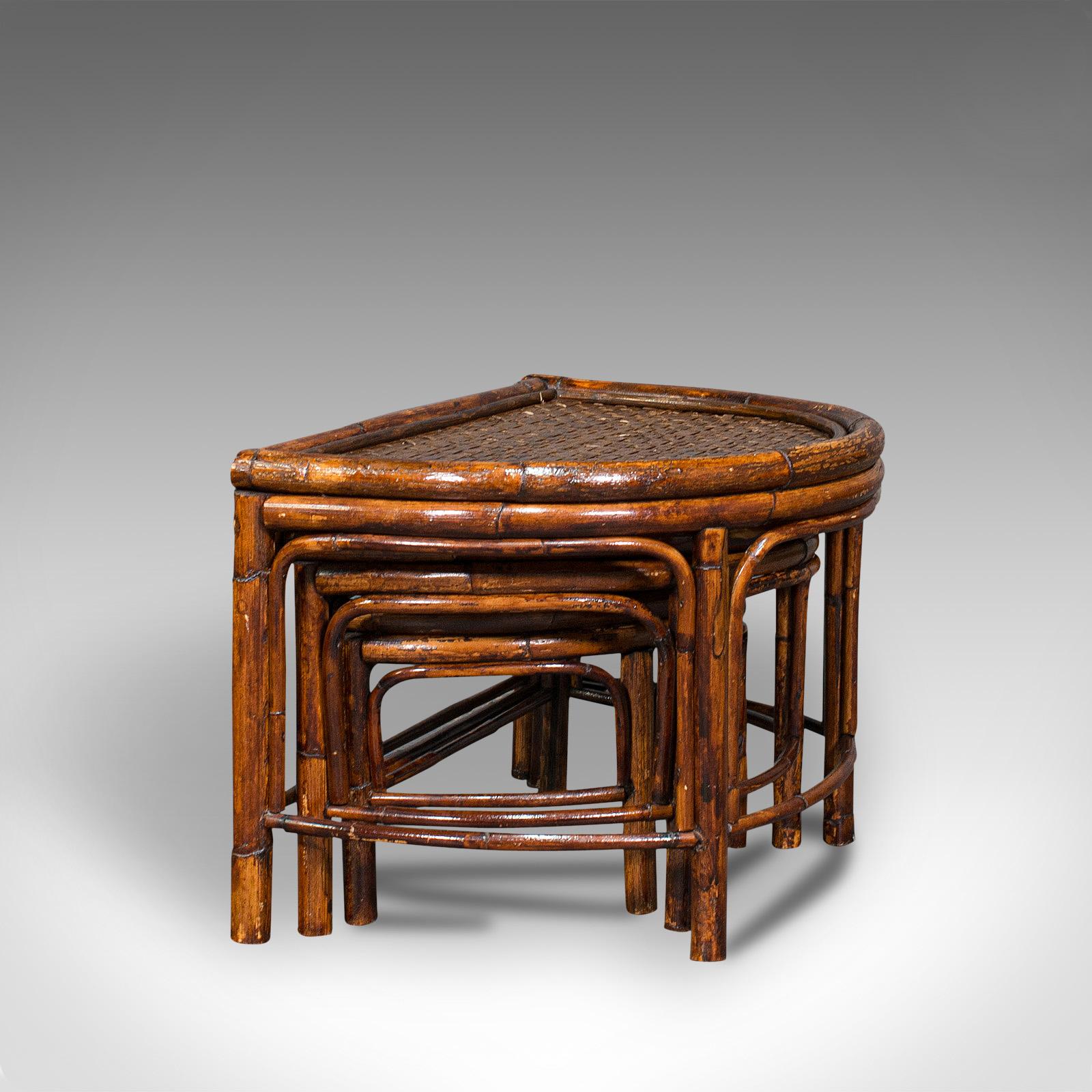 This is an antique set of nesting tables. An Oriental, bamboo and rattan occasional side table, dating to the Edwardian period, circa 1910.

Compact nesting tables with a charming appearance
Displaying a desirable aged patina throughout
Bamboo