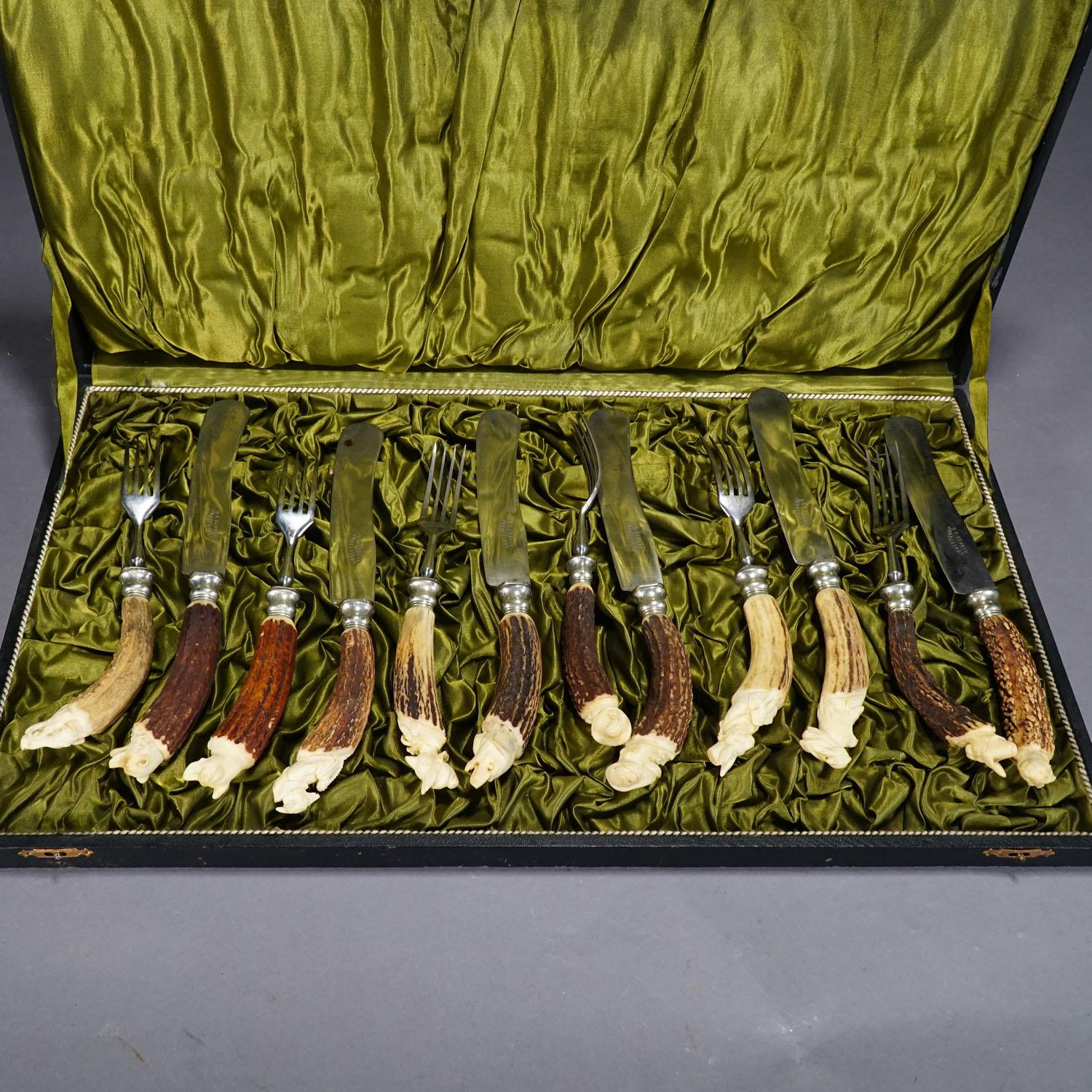 A rare antique set of 6 knives and 6 forkes in a lidded box. The handles are made of deer Horn with hand carved animal sculptures on their end. There are hare, fox, bear, dog, wolf, cock, etc. the animals are carved after caracters of the fables of