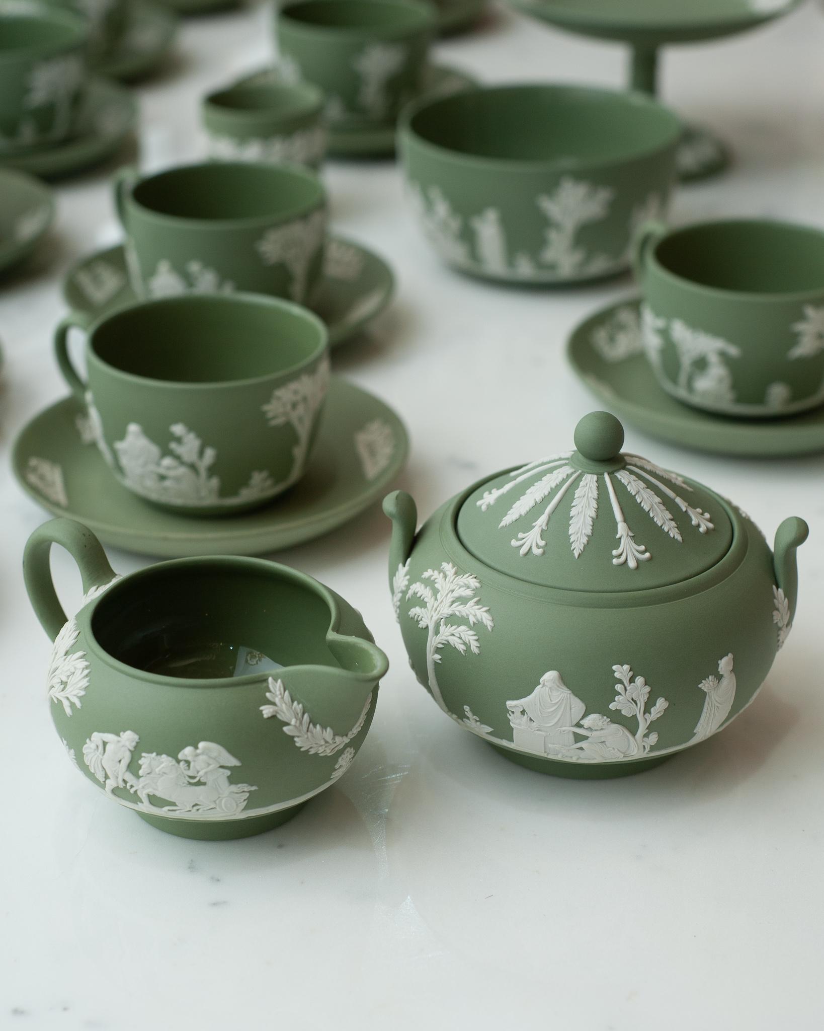 A stunning antique set of Wedgwood sage green jasperware sugar bowl with lid and creamer with white overlay.