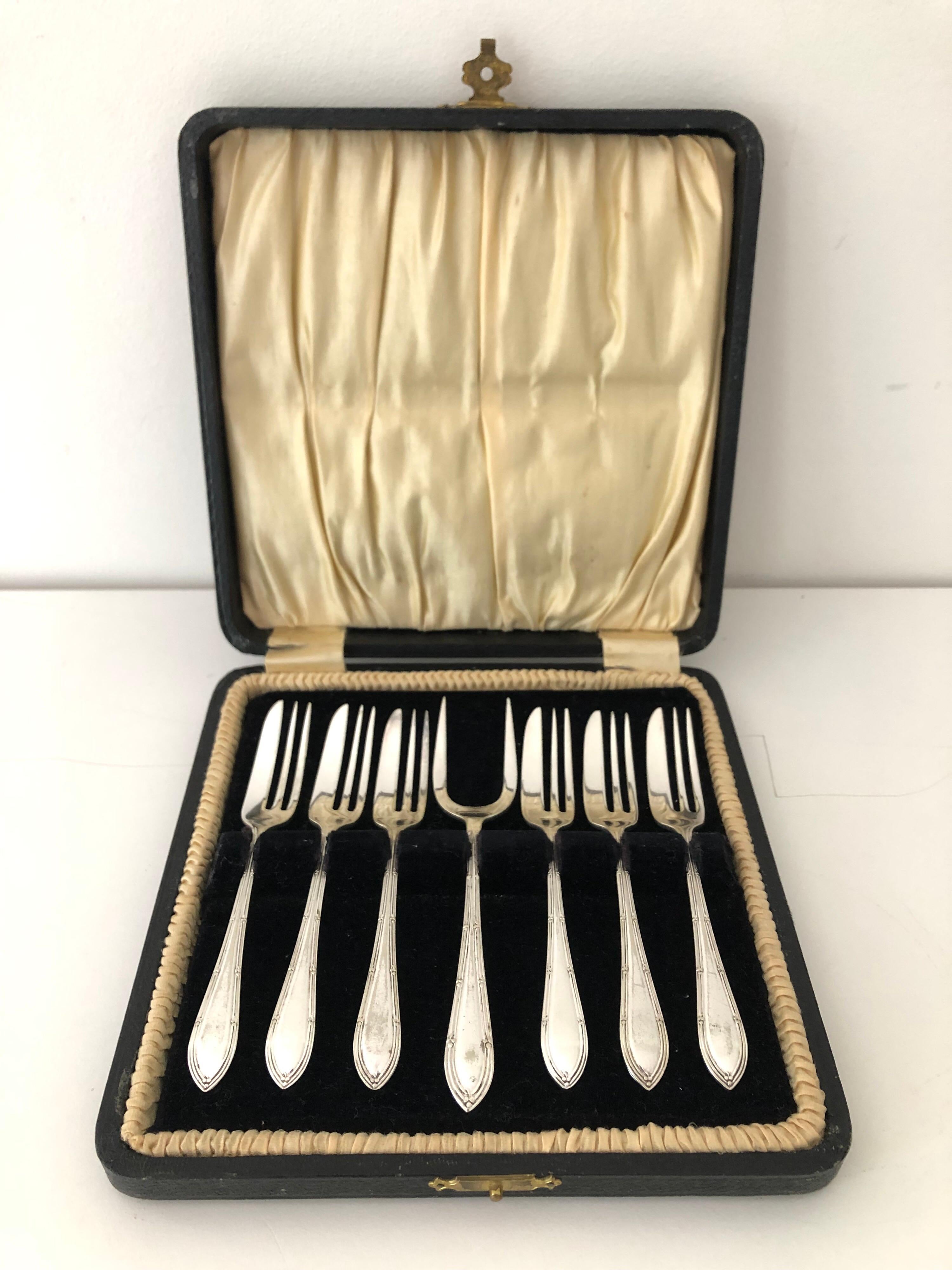 An antique set of silver plate fish forks. Includes original box.