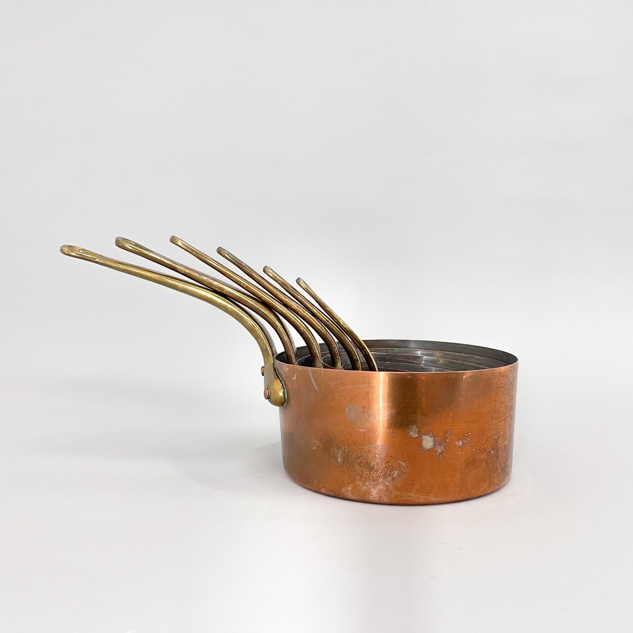 Set of six beautiful copper sauce pans. The largest is 10 cm high, is 21 cm in diameter and 39 cm long (with handle). The smallest is 5 cm high, has 10 cm in diameter and is 17 cm long (with handle).