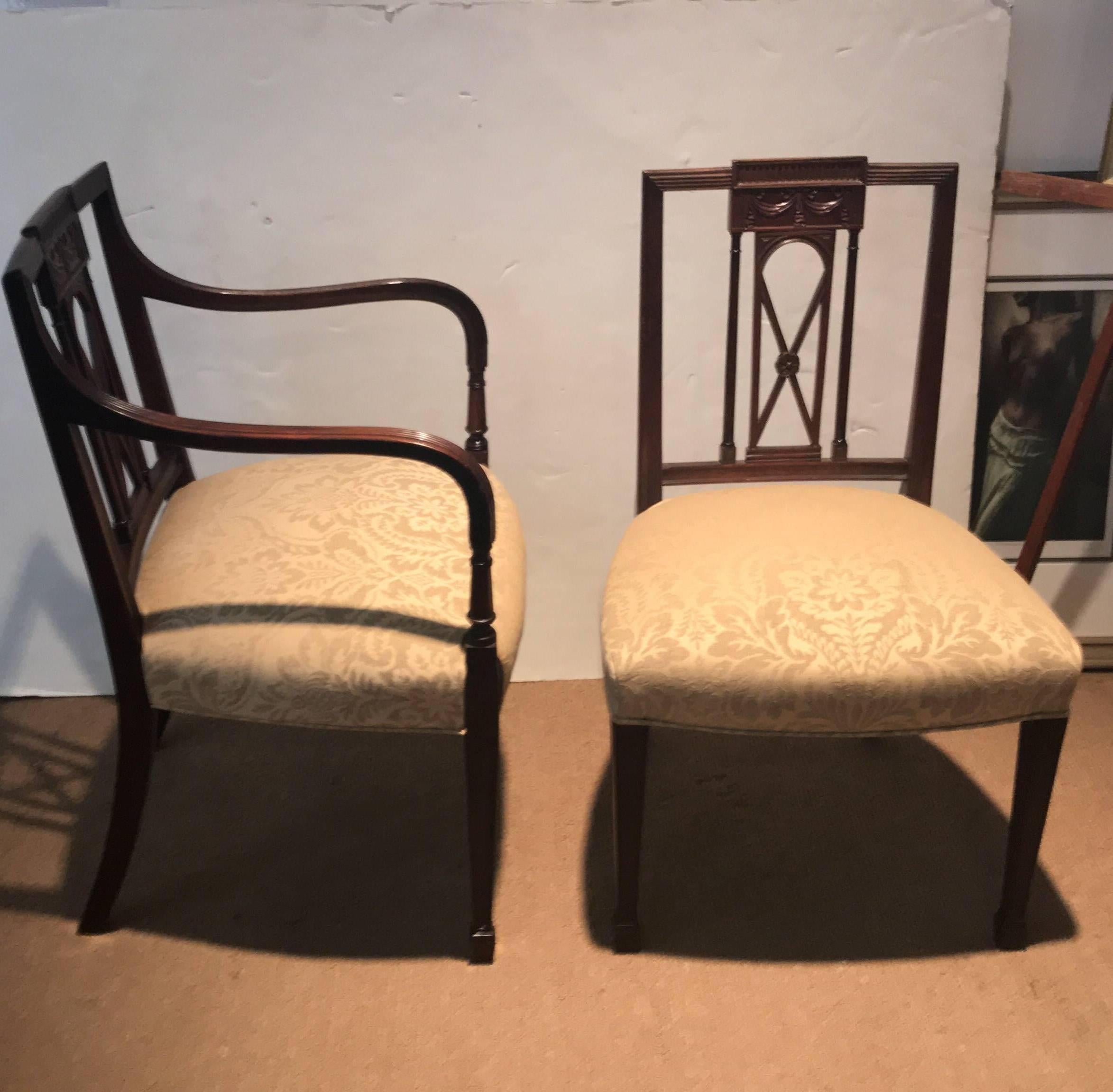 Hand-carved mahogany in a simplified Hepplewhite style in mahogany with new cotton linen damask upholstery. Two armchairs and four side chairs with smaller square backs and hand-carved details. The arm chairs with reeded simple arms. The square legs