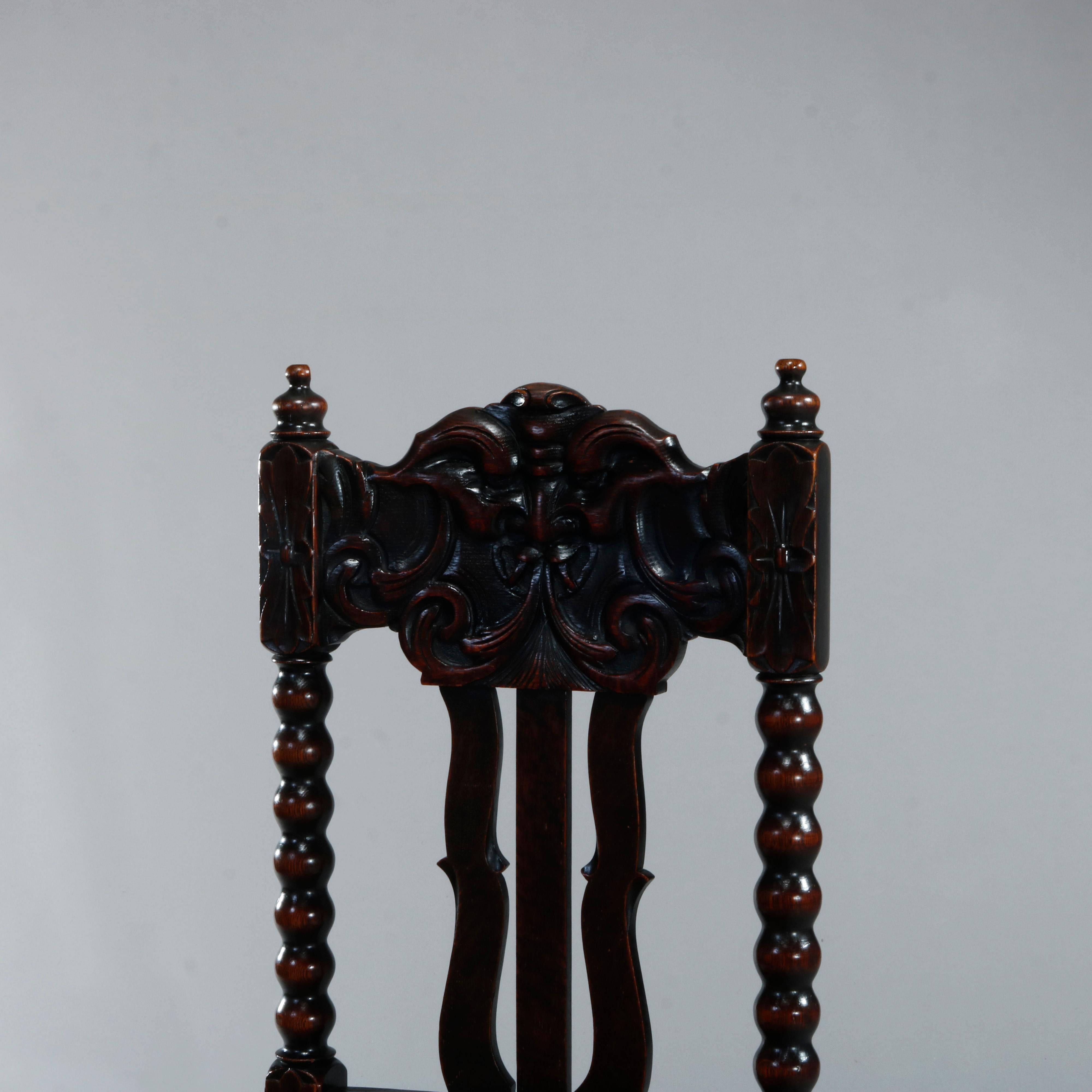 An antique set of six dining chairs in the manner of R J Horner offer oak construction with carved North Wind God tall backs surmounting stylized slat backs and leather seats, raised on carved legs having h-stretchers, c1900 

Measures: 42.75