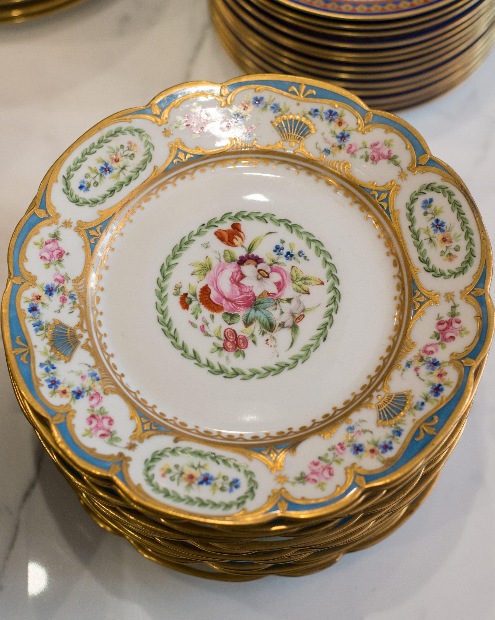 A set of 12 antique Porcelaine de Paris scalloped plates, hand printed with flowers and ornately gilded in gold.